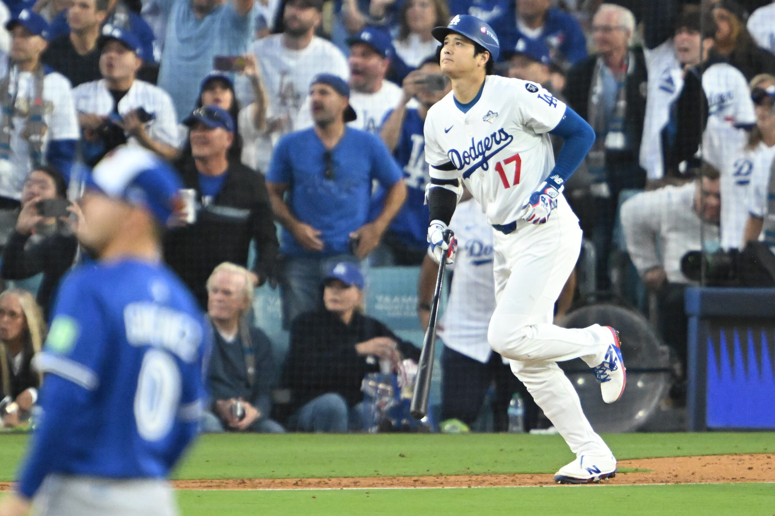 Dodgers star Shohei Ohtani watches the flight of his solo...