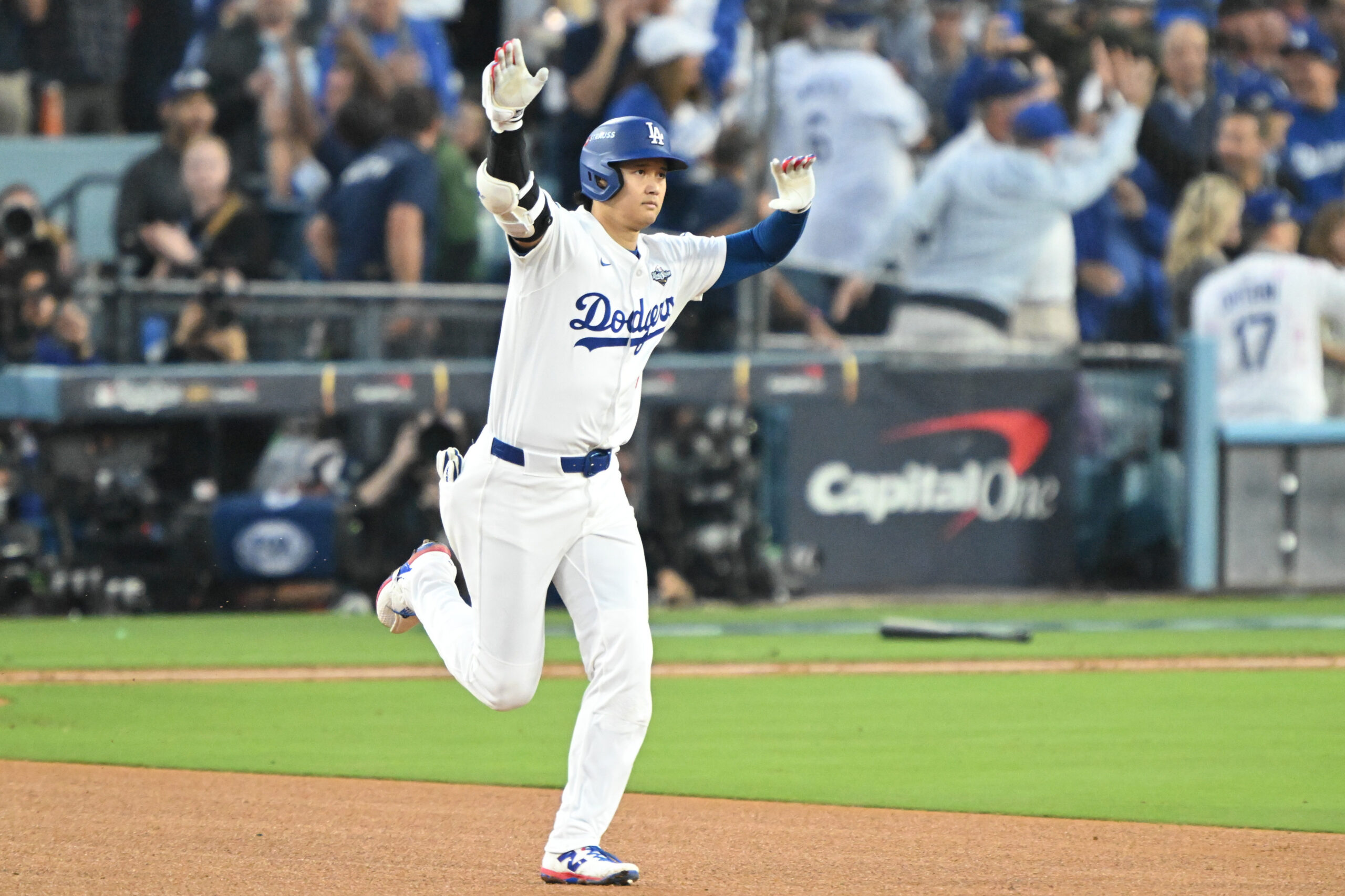 Dodgers star Shohei Ohtani gestures as he runs the bases...