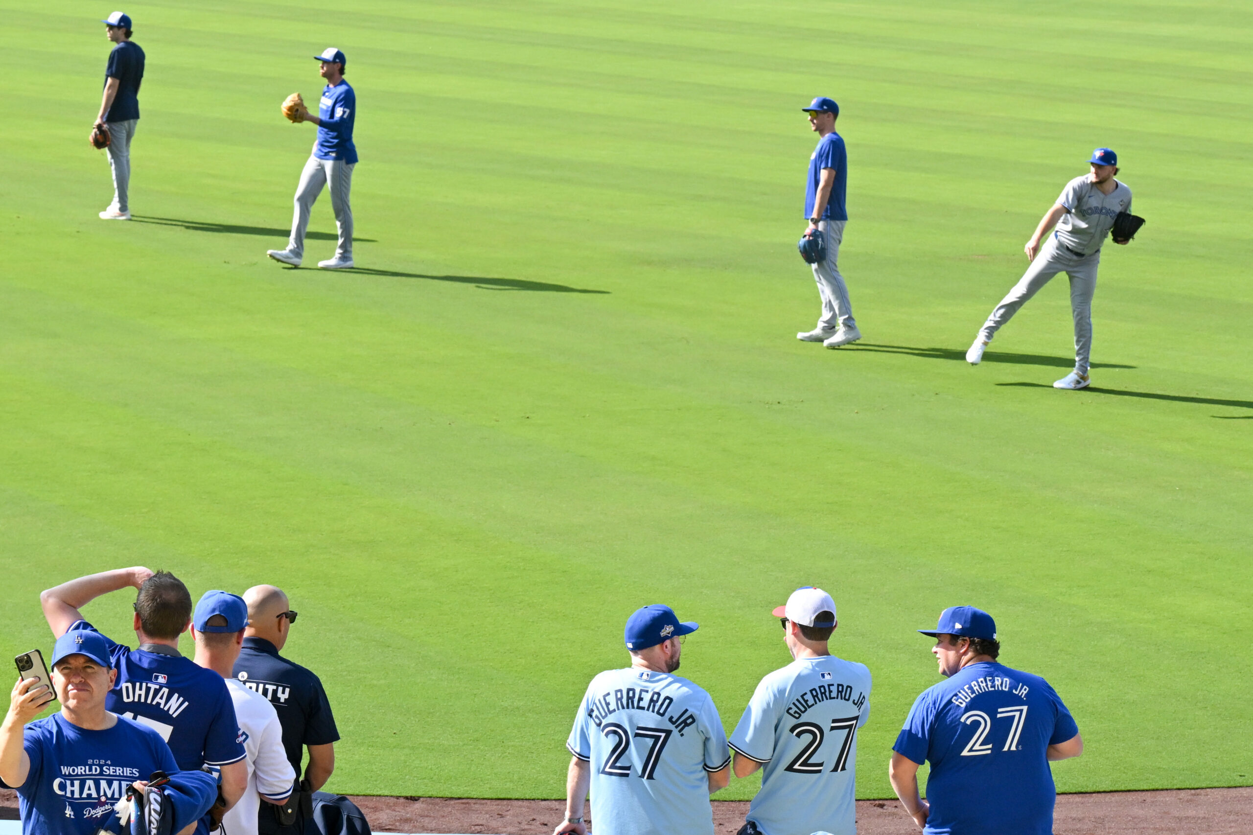 Fans watch the Toronto Blue Jays warm up for Game...