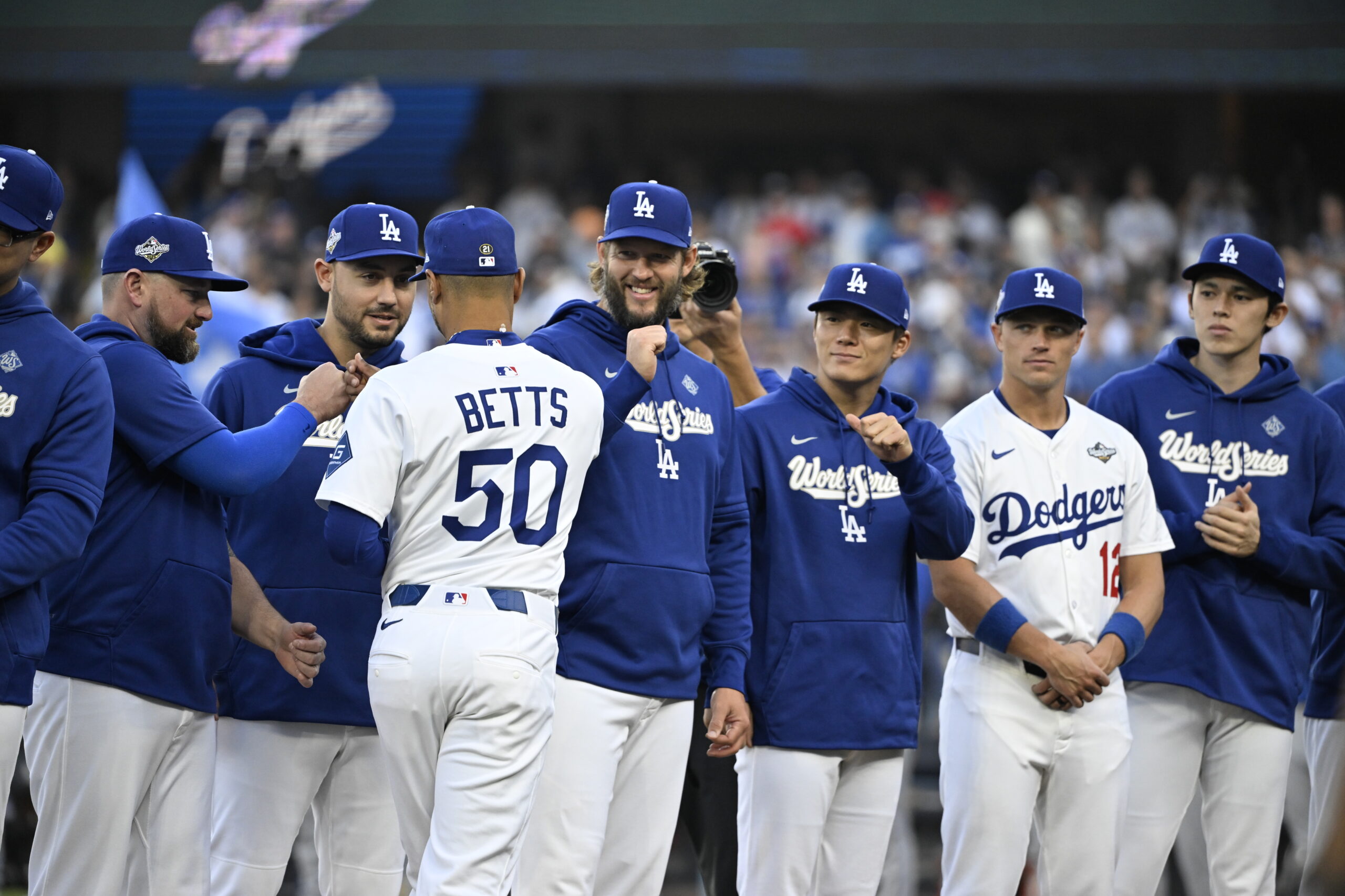 Dodgers shortstop Mookie Betts (50) greets his teammates during introductions...
