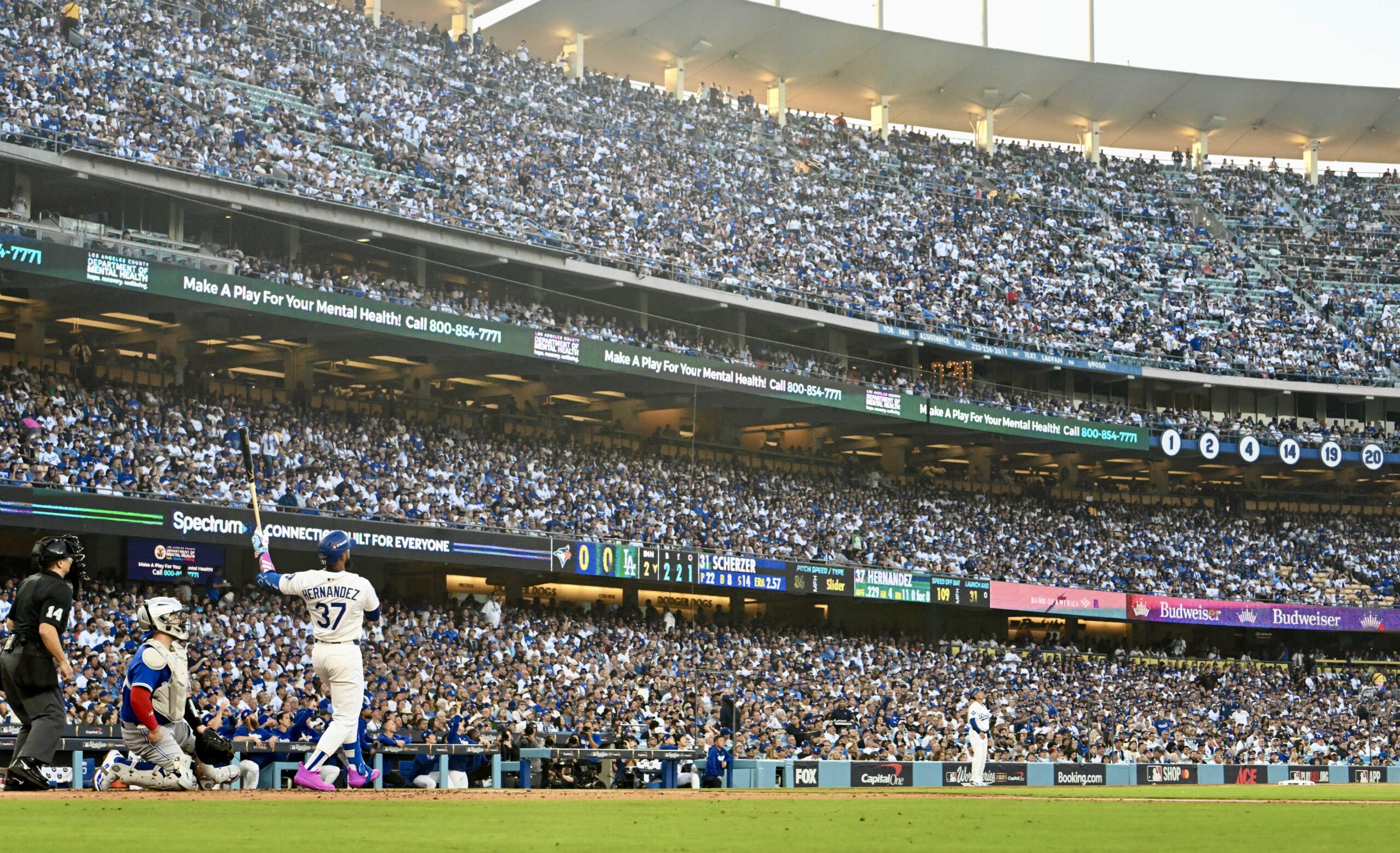 The Dodgers’ Teoscar Hernández (37) watches the flight of his...