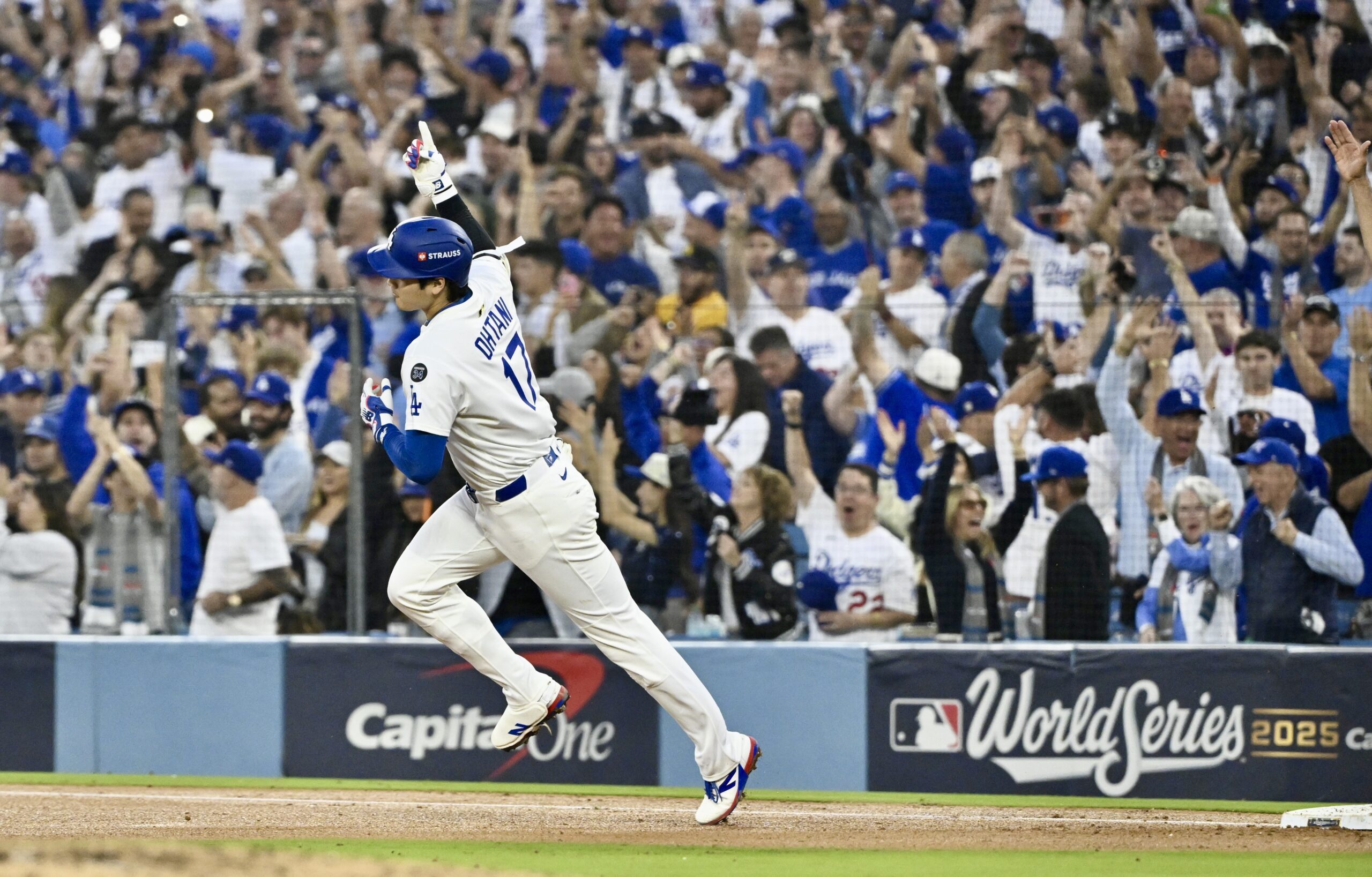 Dodgers star Shohei Ohtani rounds first base after hitting a...