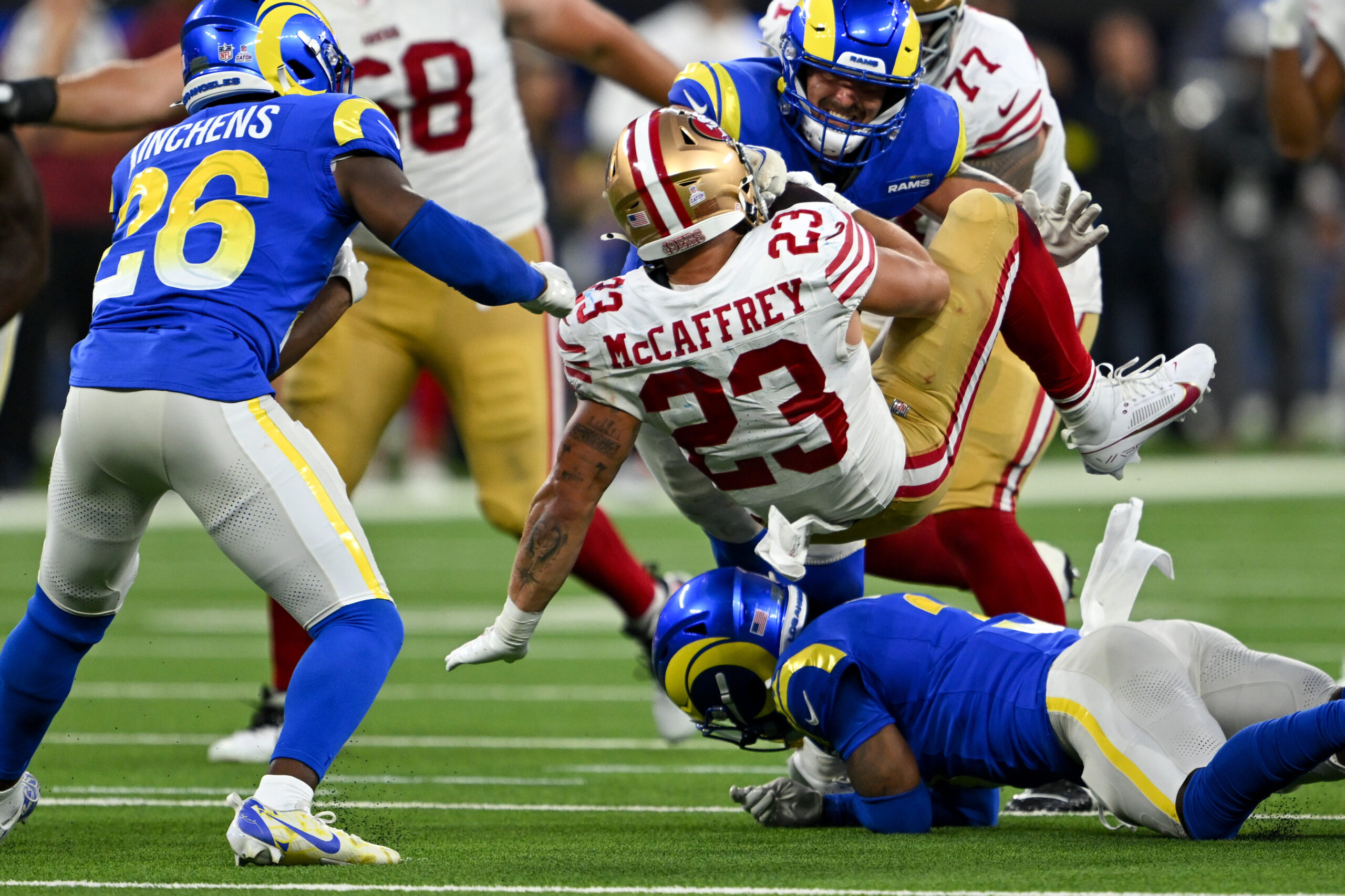 San Francisco 49ers running back Christian McCaffrey tries to fall...