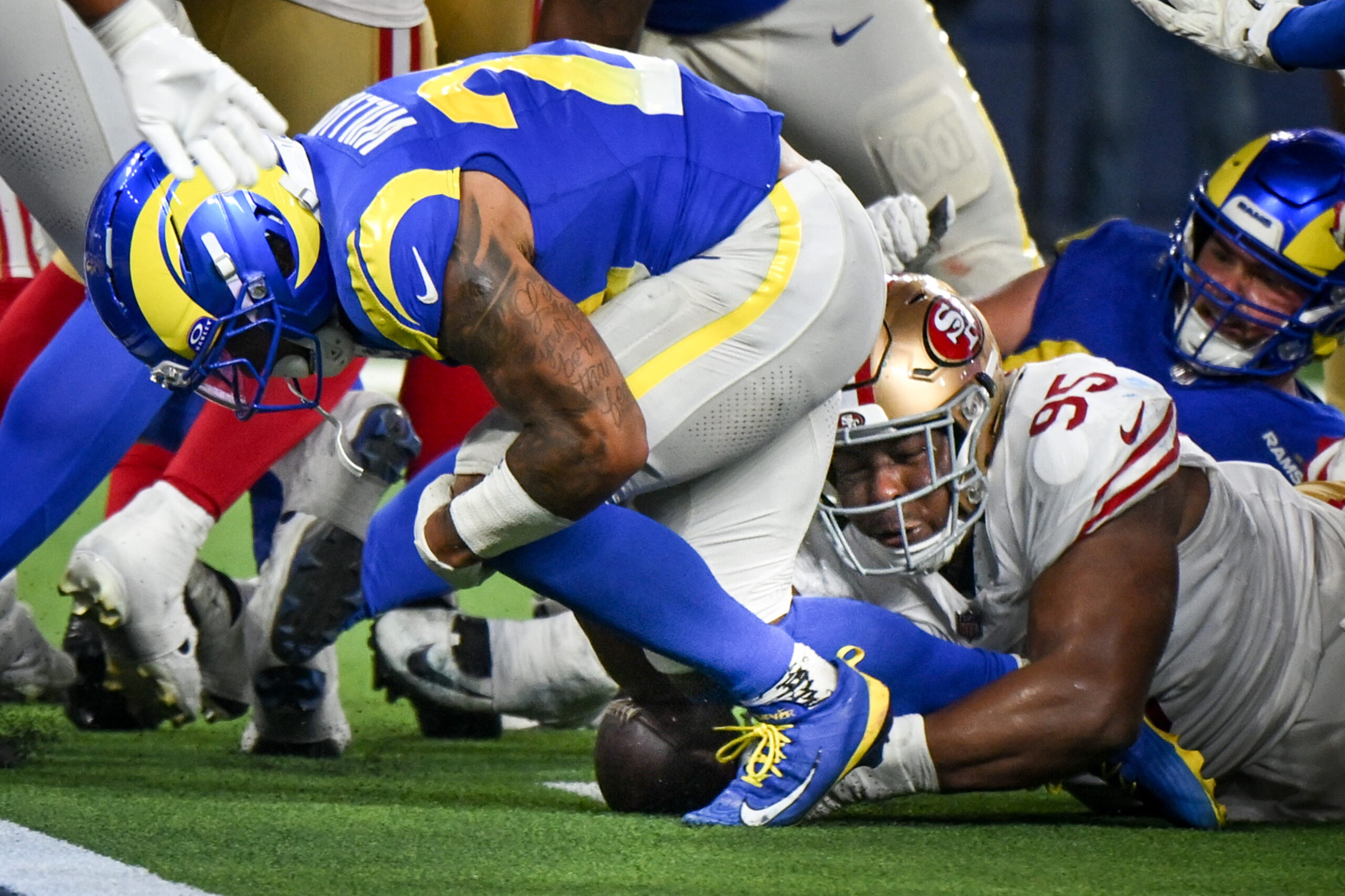 San Francisco 49ers defensive lineman Alfred Collins (95) forces Rams...