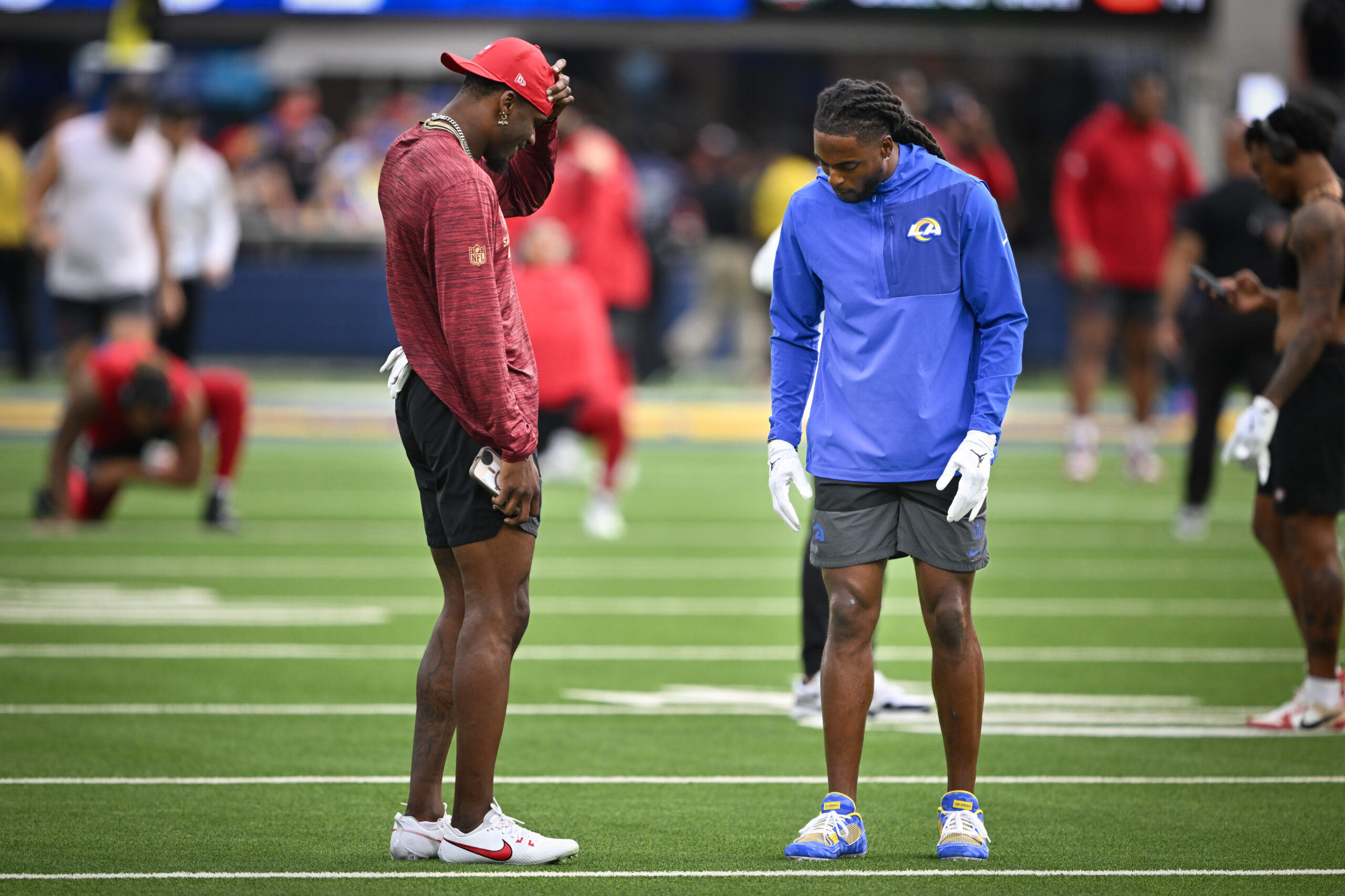 San Francisco 49ers wide receiver Marquez Valedes-Scantling, left, checks out...