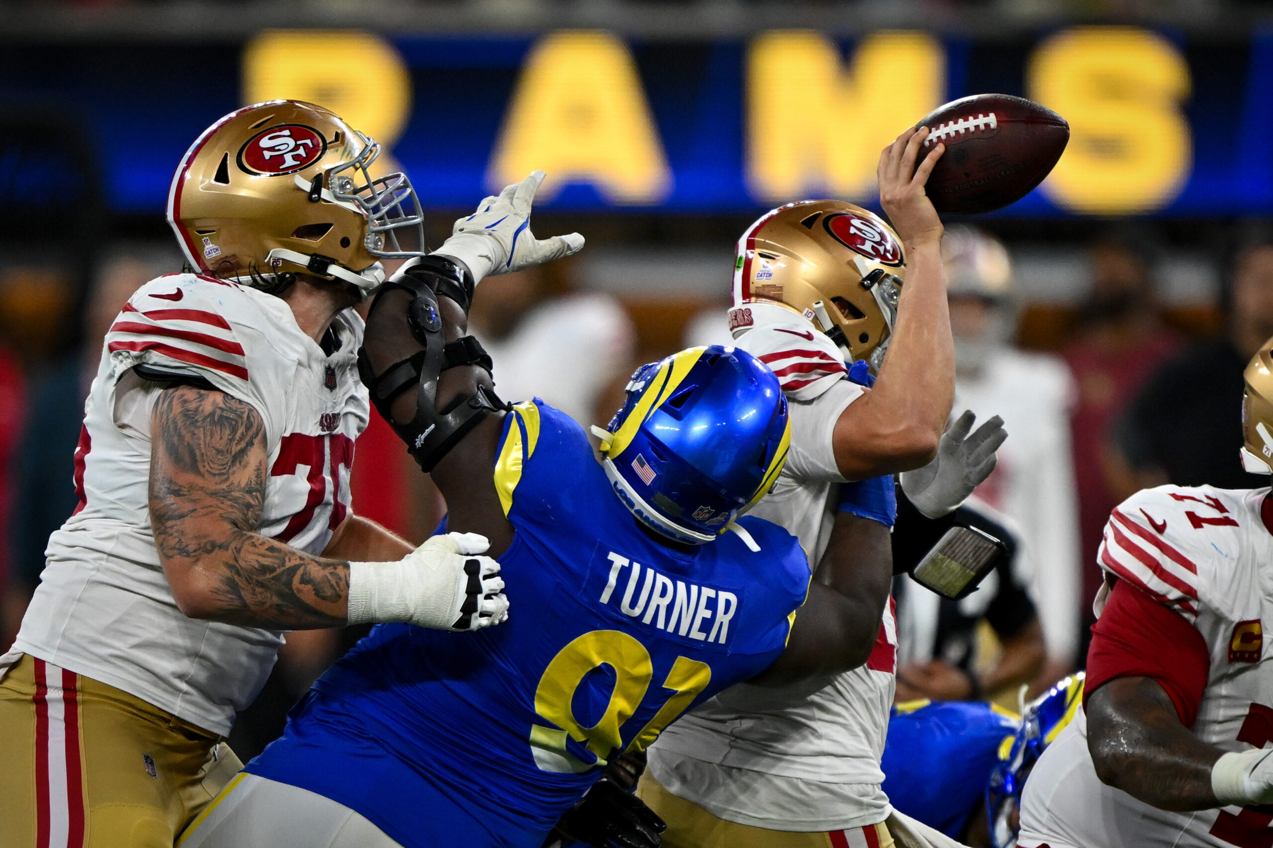 Rams Kobie Turner (91) puts pressure on 49ers QB Mac...
