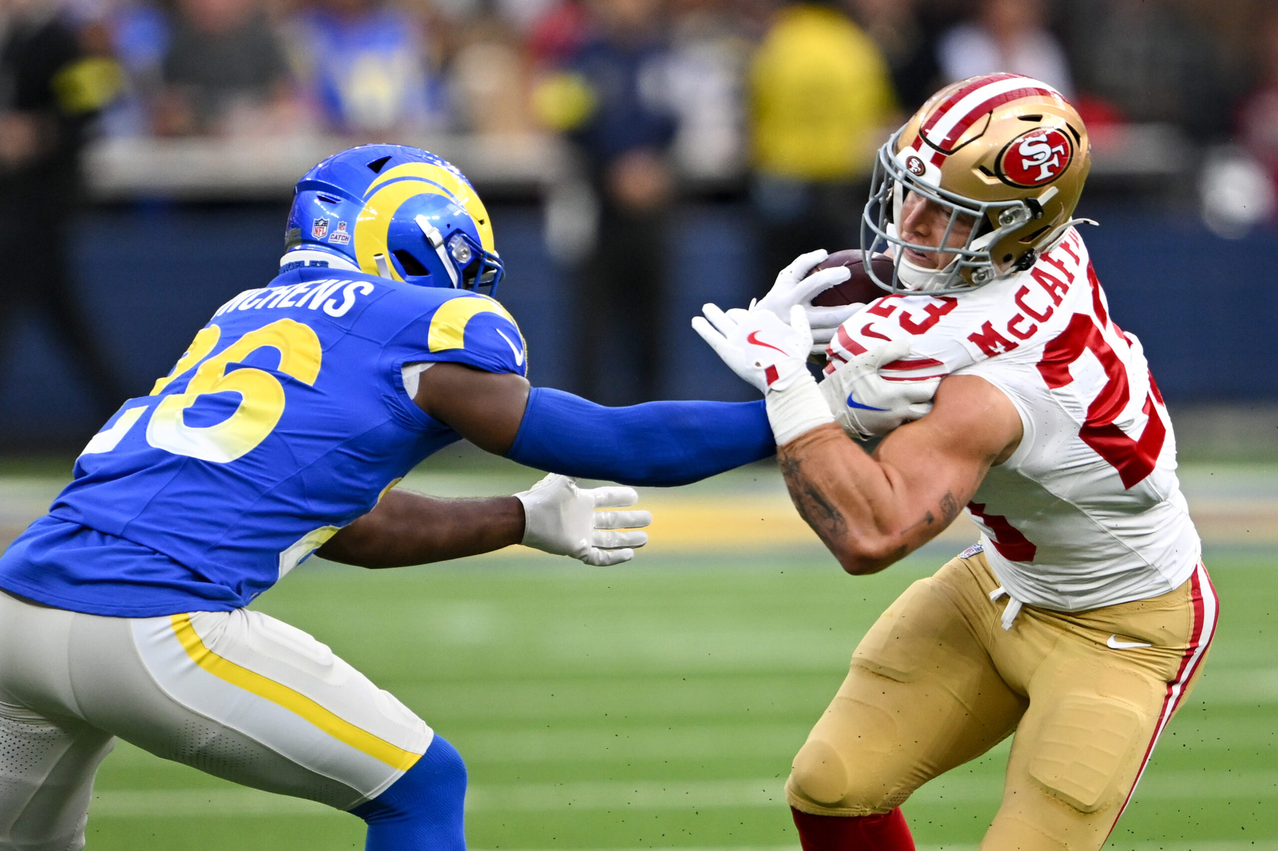 Rams safety Kamren Kinchens, left, pulls down San Francisco 49ers...