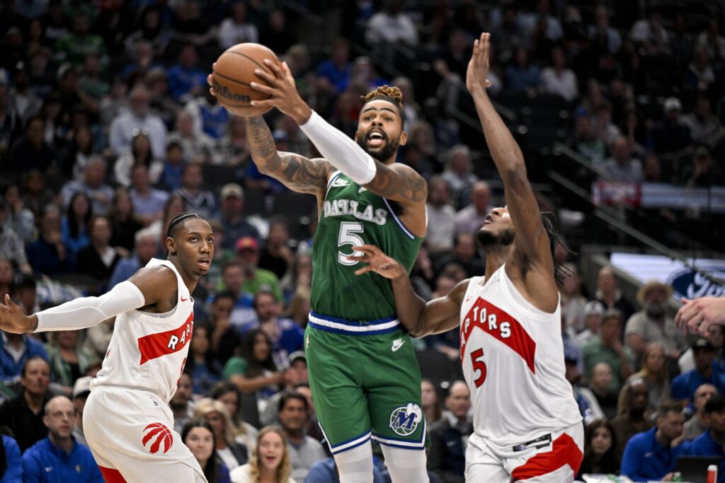 Oct 26, 2025; Dallas, Texas, USA; Dallas Mavericks guard D'Angelo Russell (5) drives to the basket past Toronto Raptors guard Immanuel Quickley (5) during the second half at the American Airlines Center. Mandatory Credit: Jerome Miron-Imagn Images