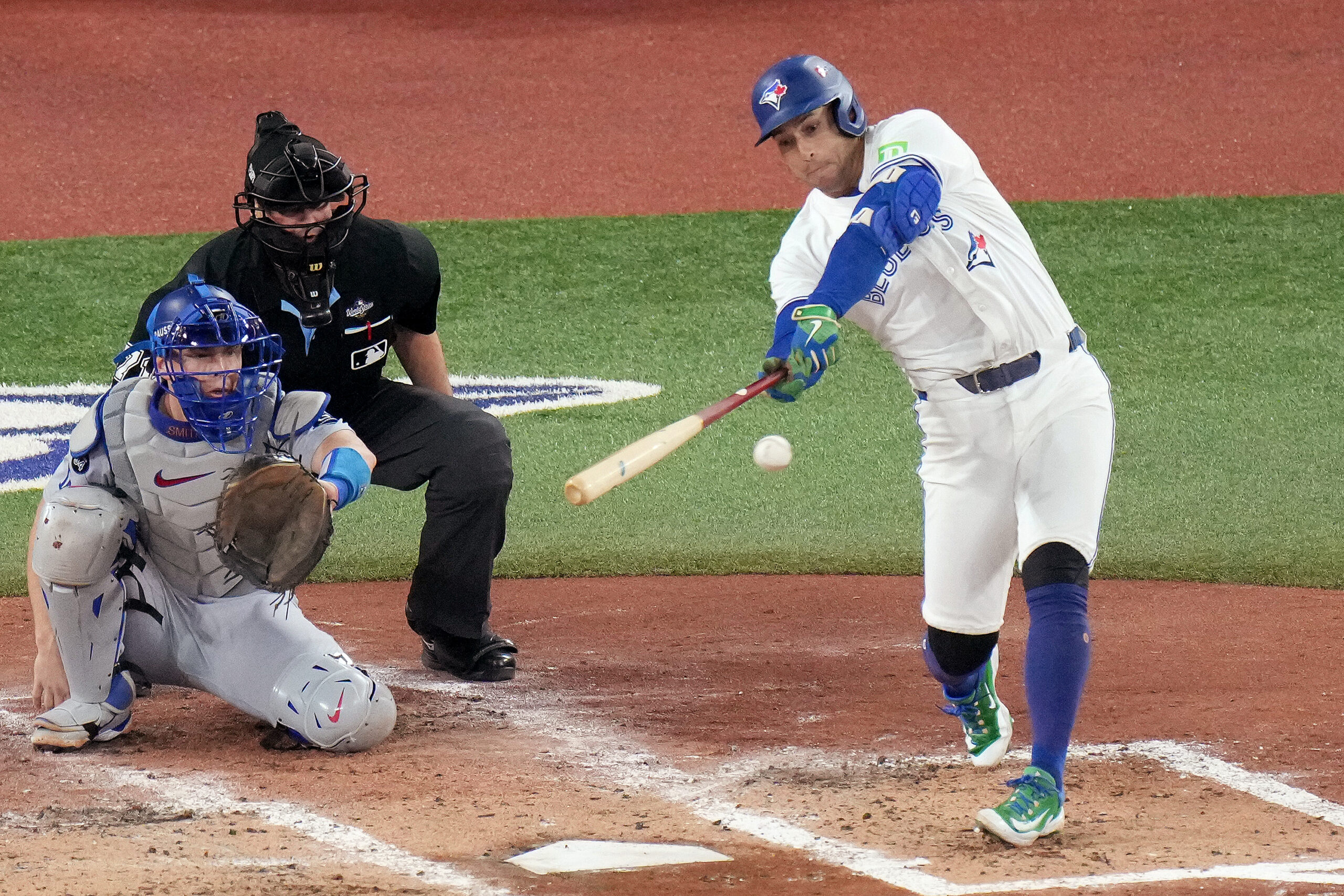 The Toronto Blue Jays’ George Springer, right, hits a single...