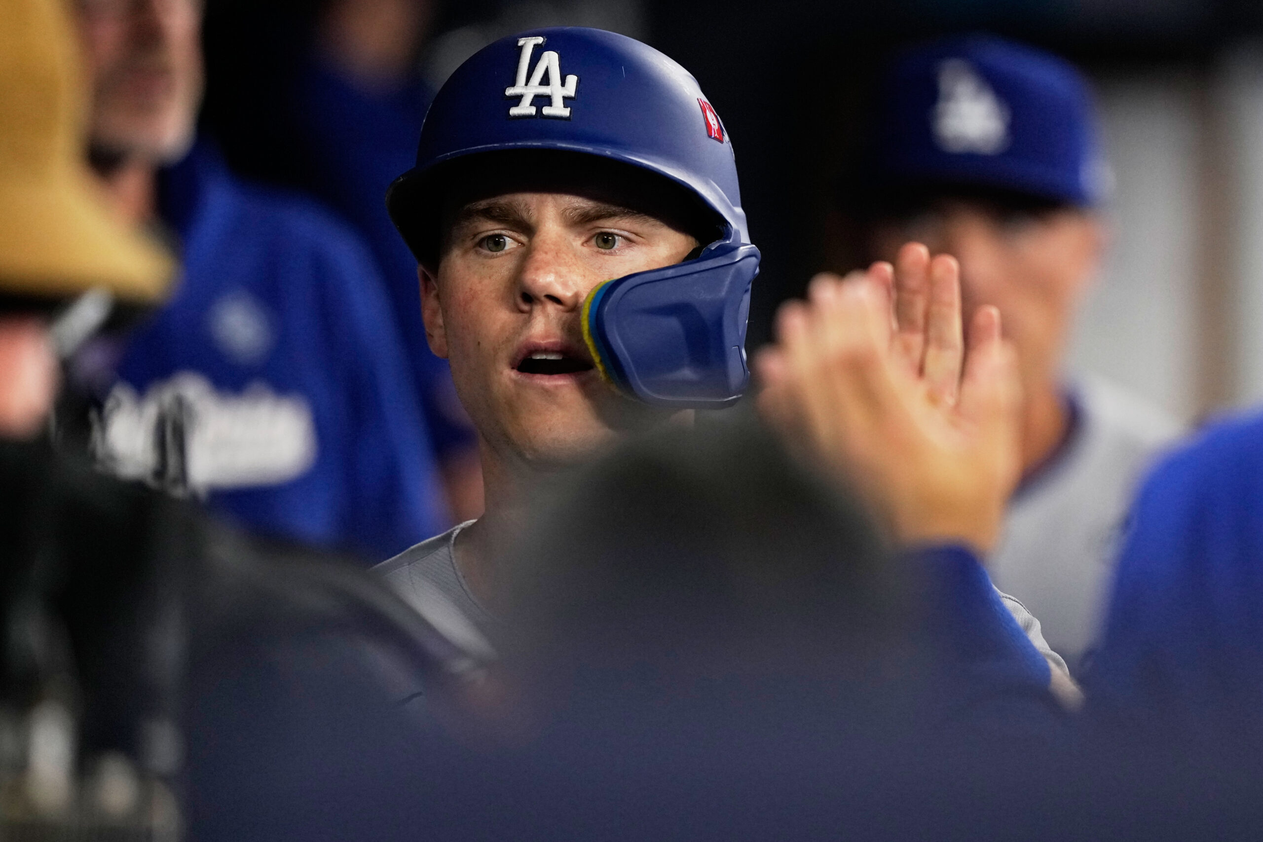 The Dodgers’ Will Smith celebrates in the dugout after scoring...
