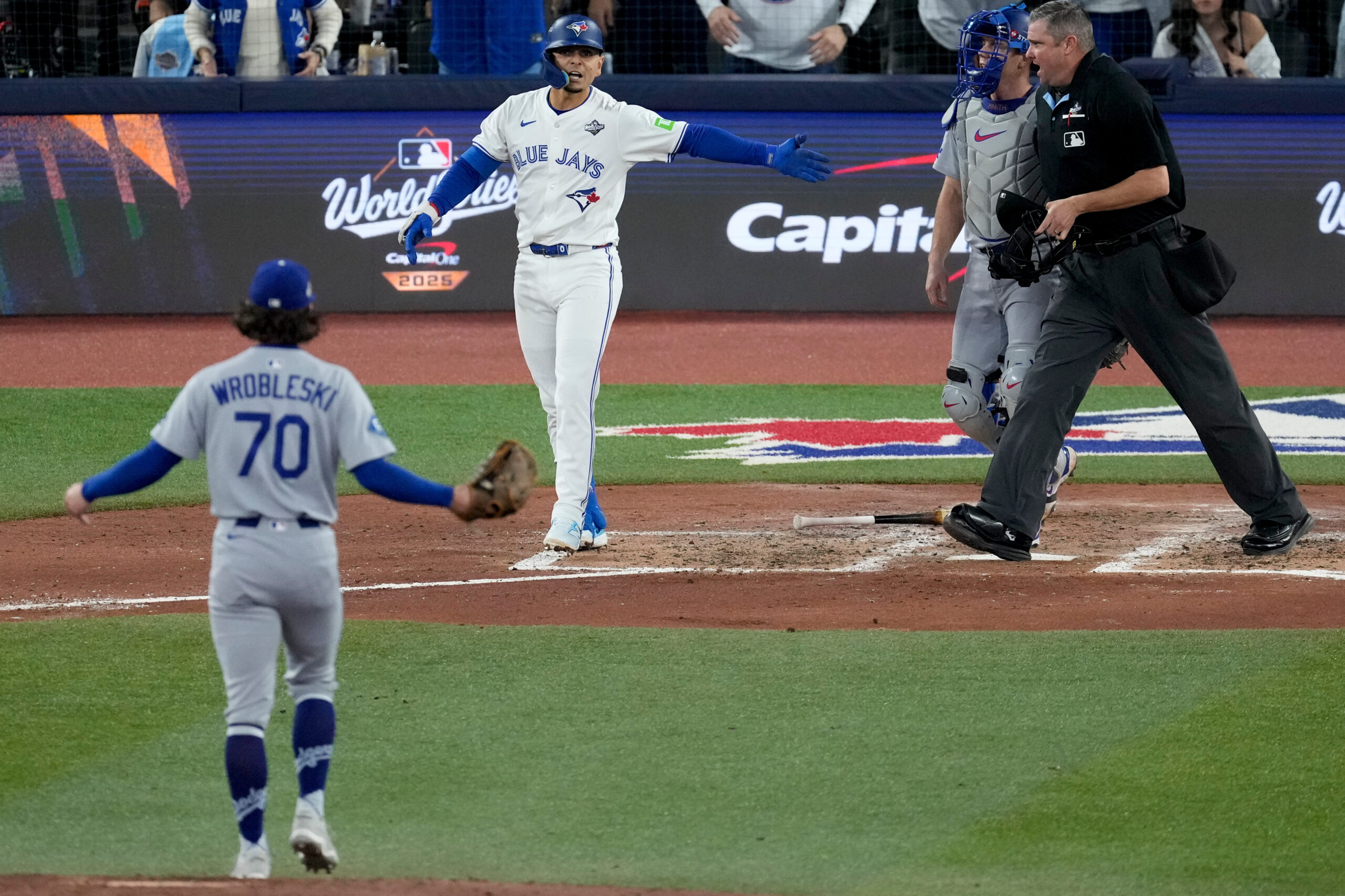 The Toronto Blue Jays’ Andrés Giménez reacts after being hit...