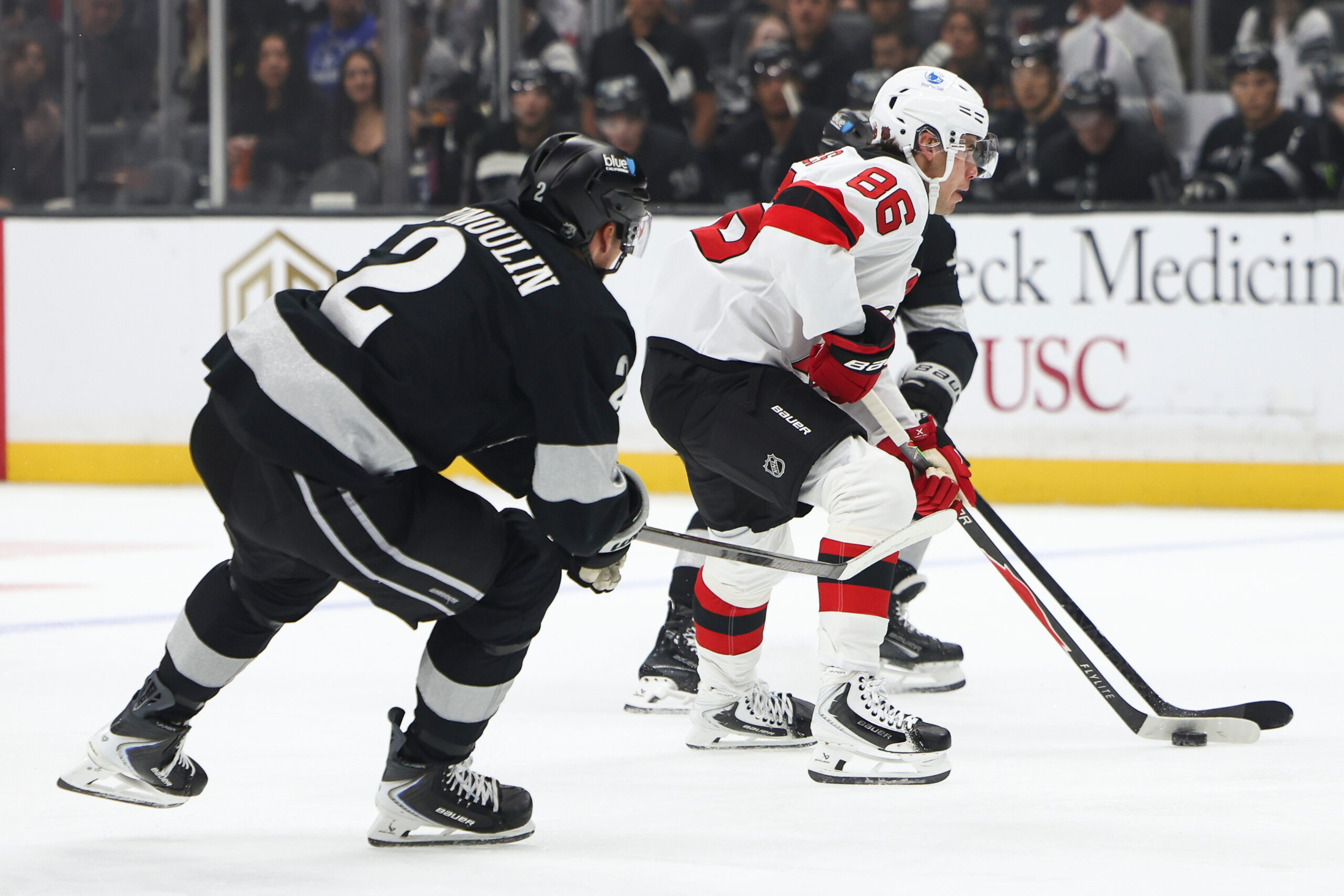 New Jersey Devils center Jack Hughes (86) skates with the...