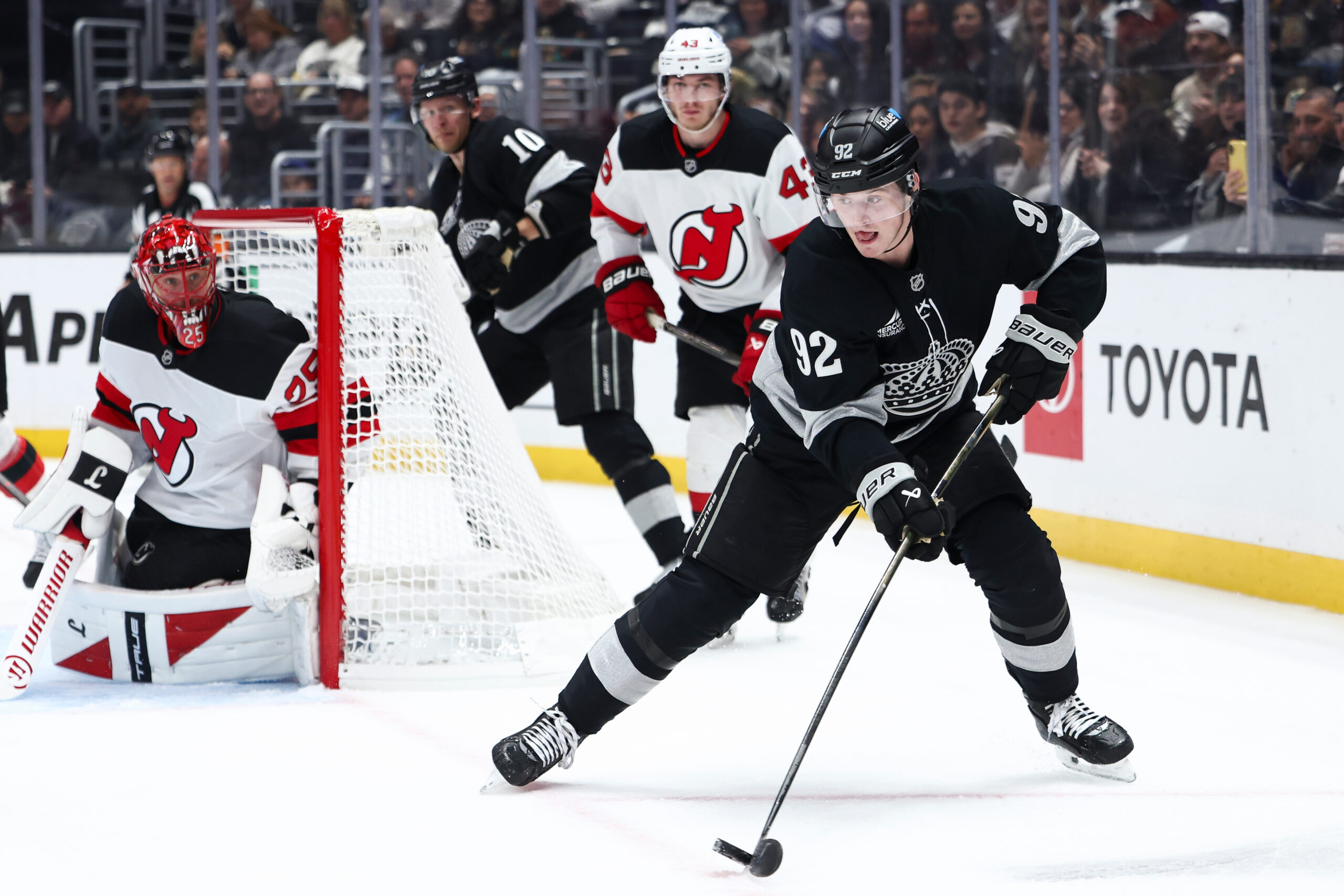 Kings defenseman Brandt Clarke (92) skates with the puck as...