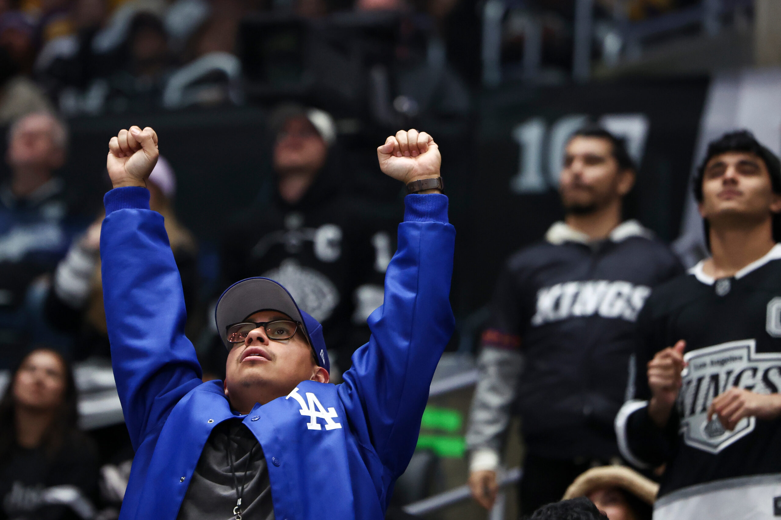 A Dodgers fan celebrates after watching a home run hit...