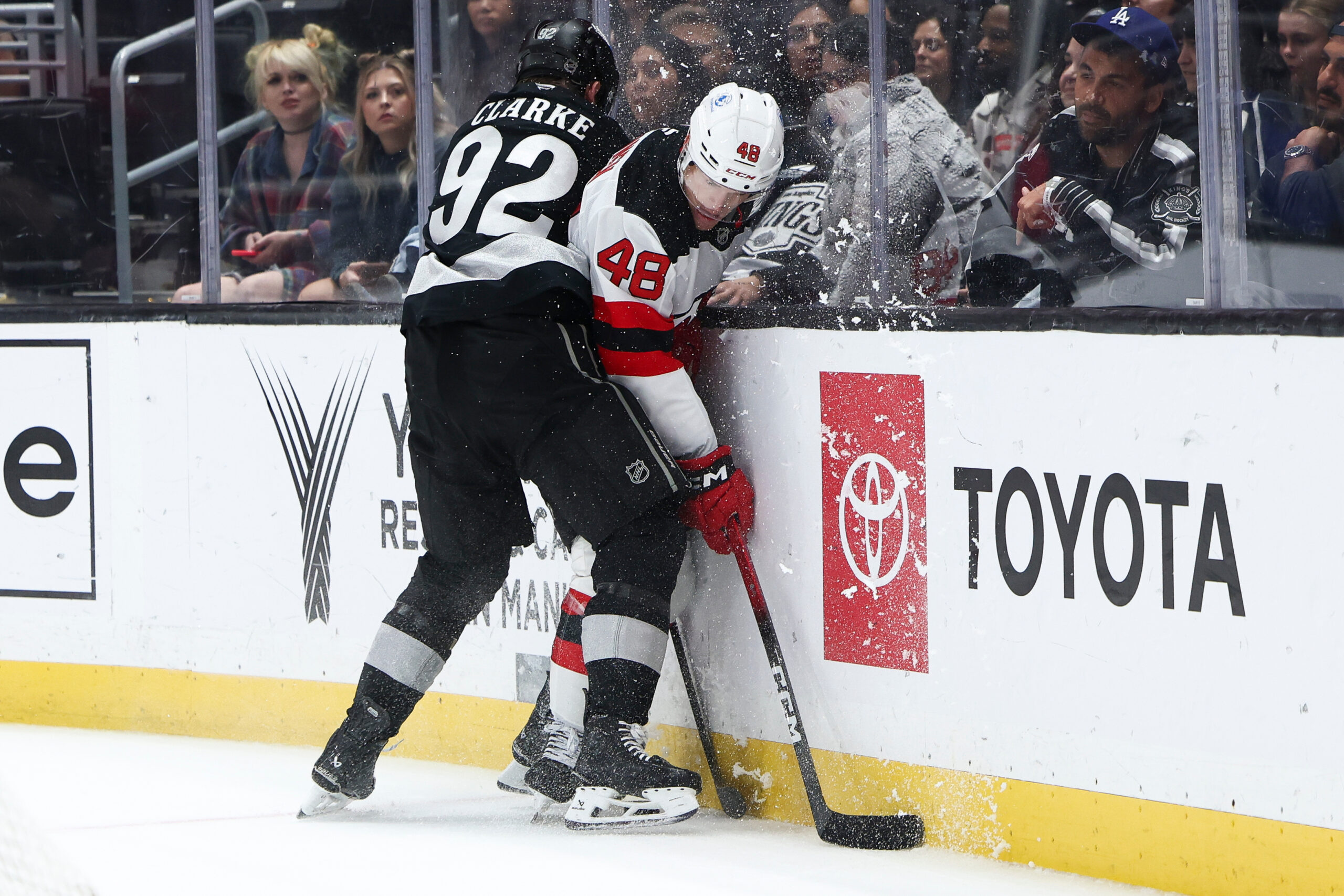 Kings defenseman Brandt Clarke (92) checks New Jersey Devils left...