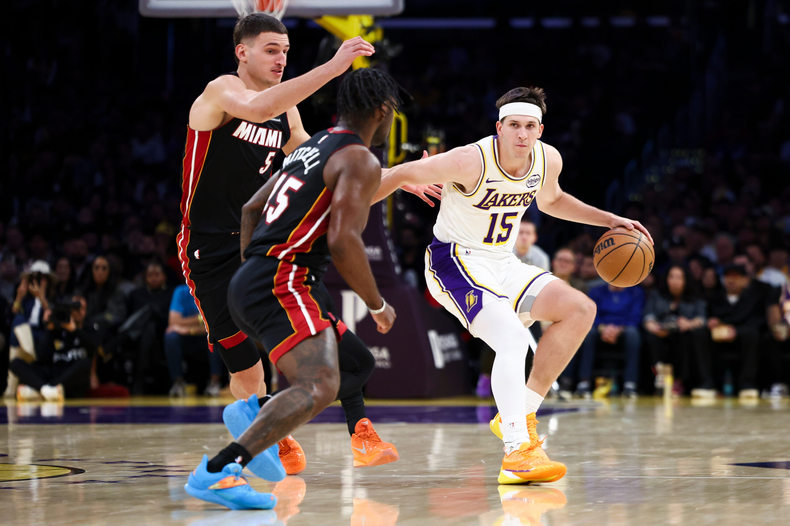 Lakers guard Austin Reaves (15) dribbles against Miami Heat forward...