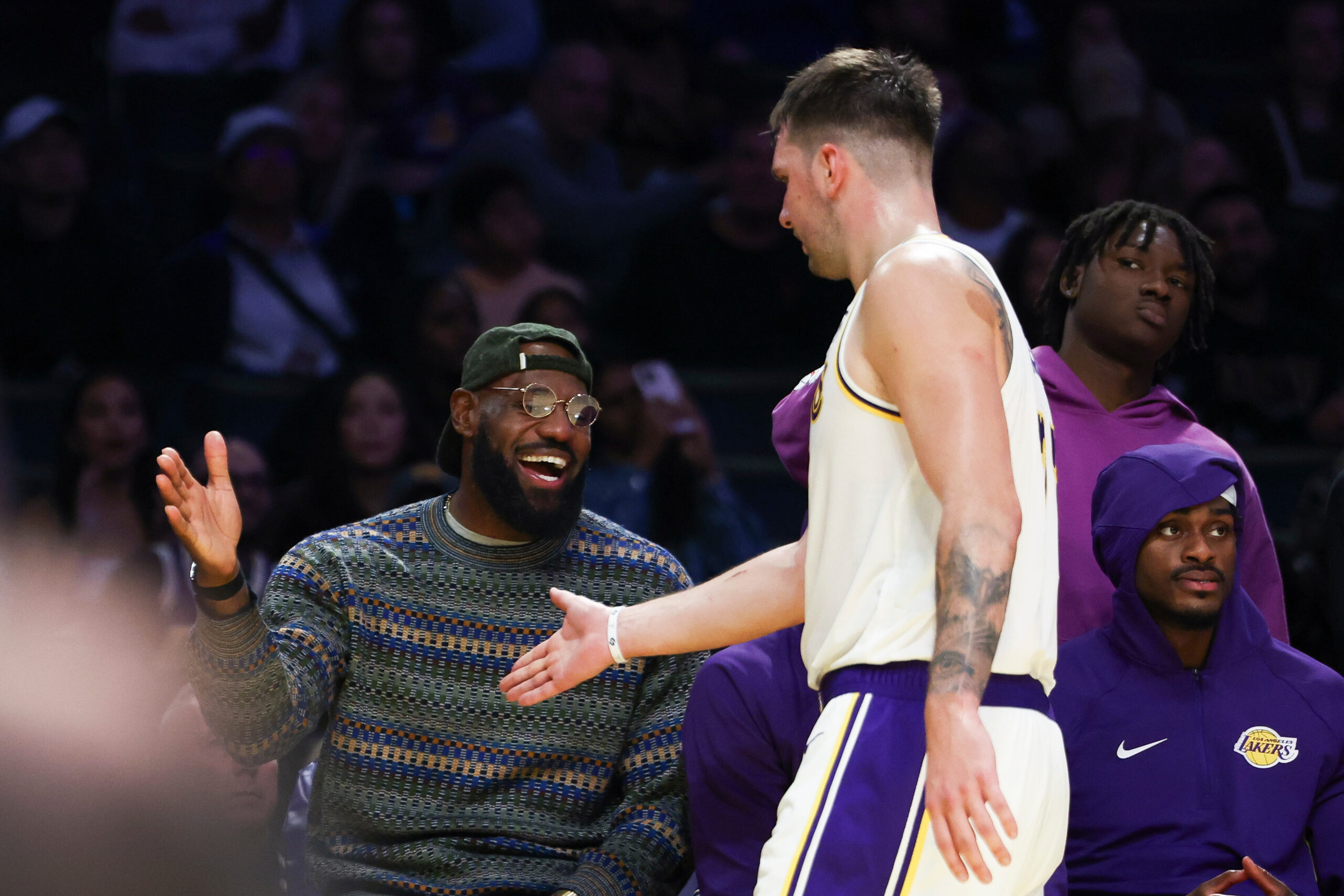 Lakers forward LeBron James, left, and guard Luka Doncic, center,...