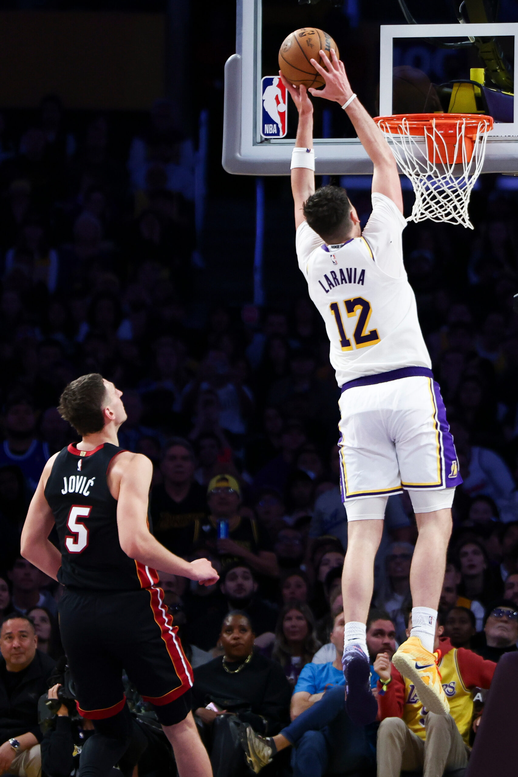 Lakers forward Jake LaRavia (12) dunks as Miami Heat forward...