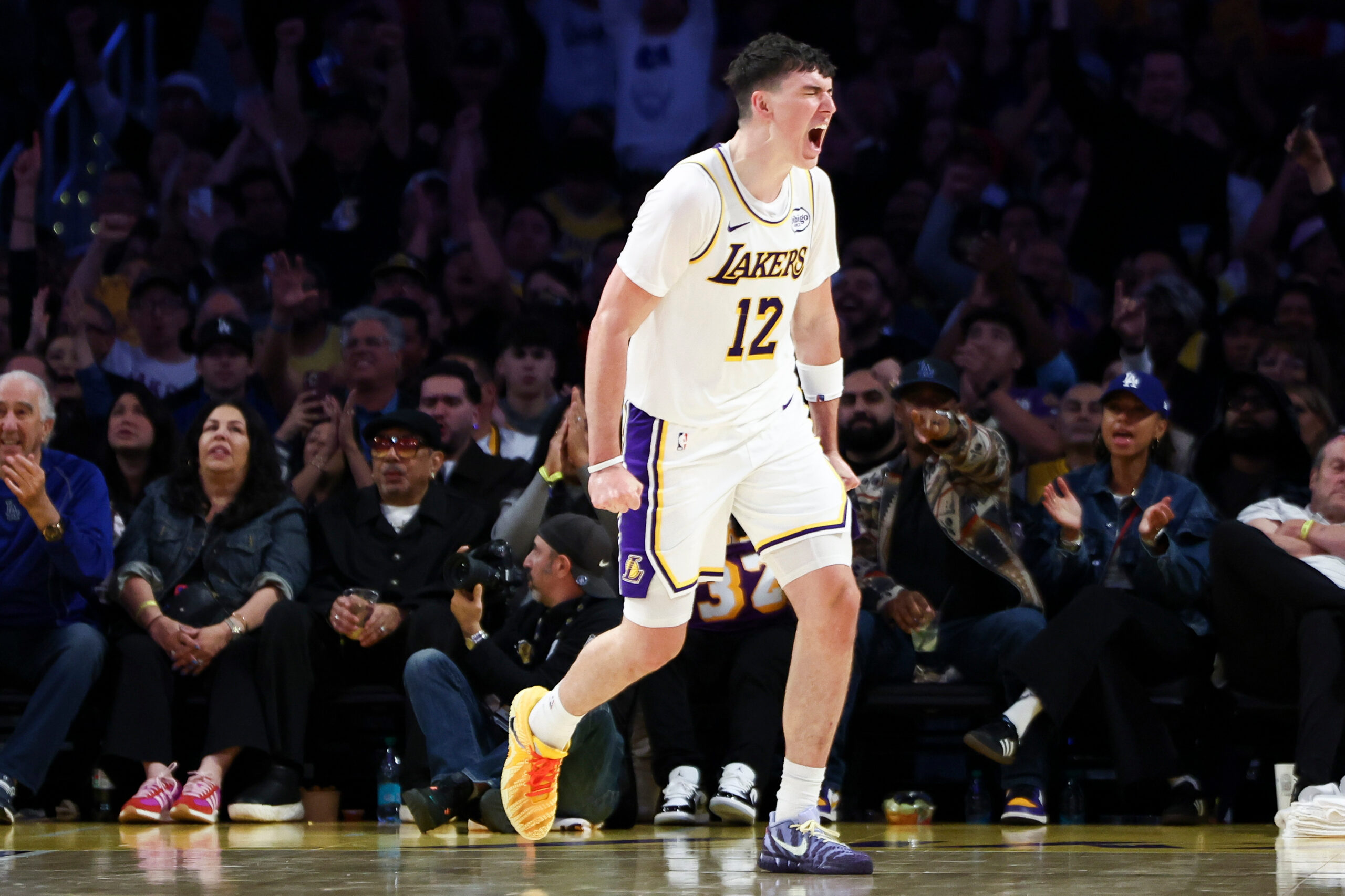 Lakers forward Jake LaRavia (12) reacts after a dunk during...