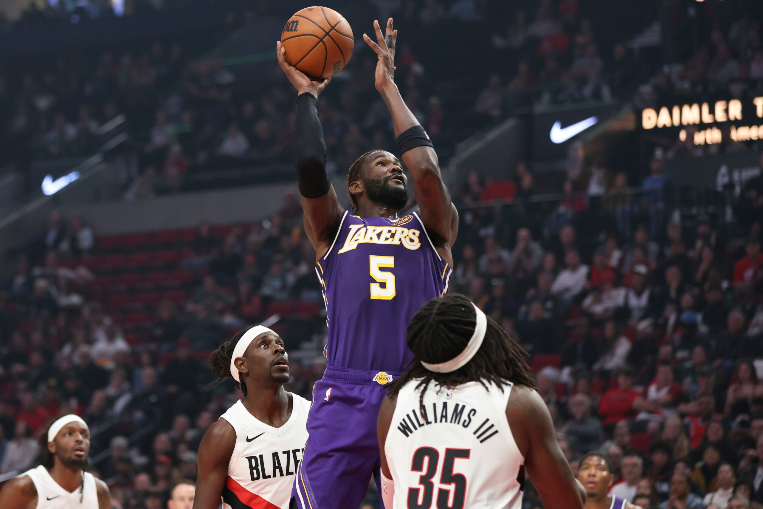 Lakers center Deandre Ayton goes up to shoot between Portland...