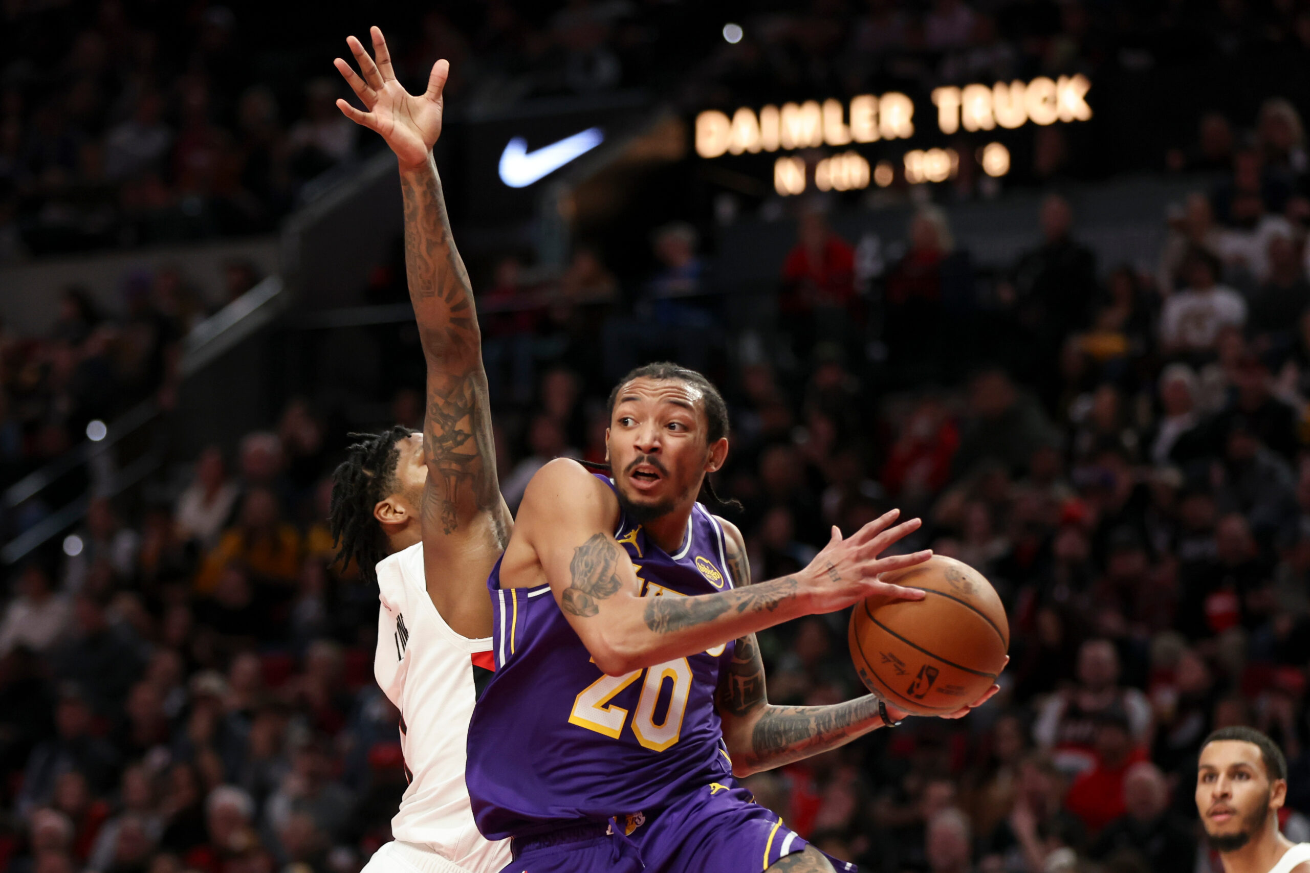 Lakers guard Nick Smith Jr., right, passes away from Portland...