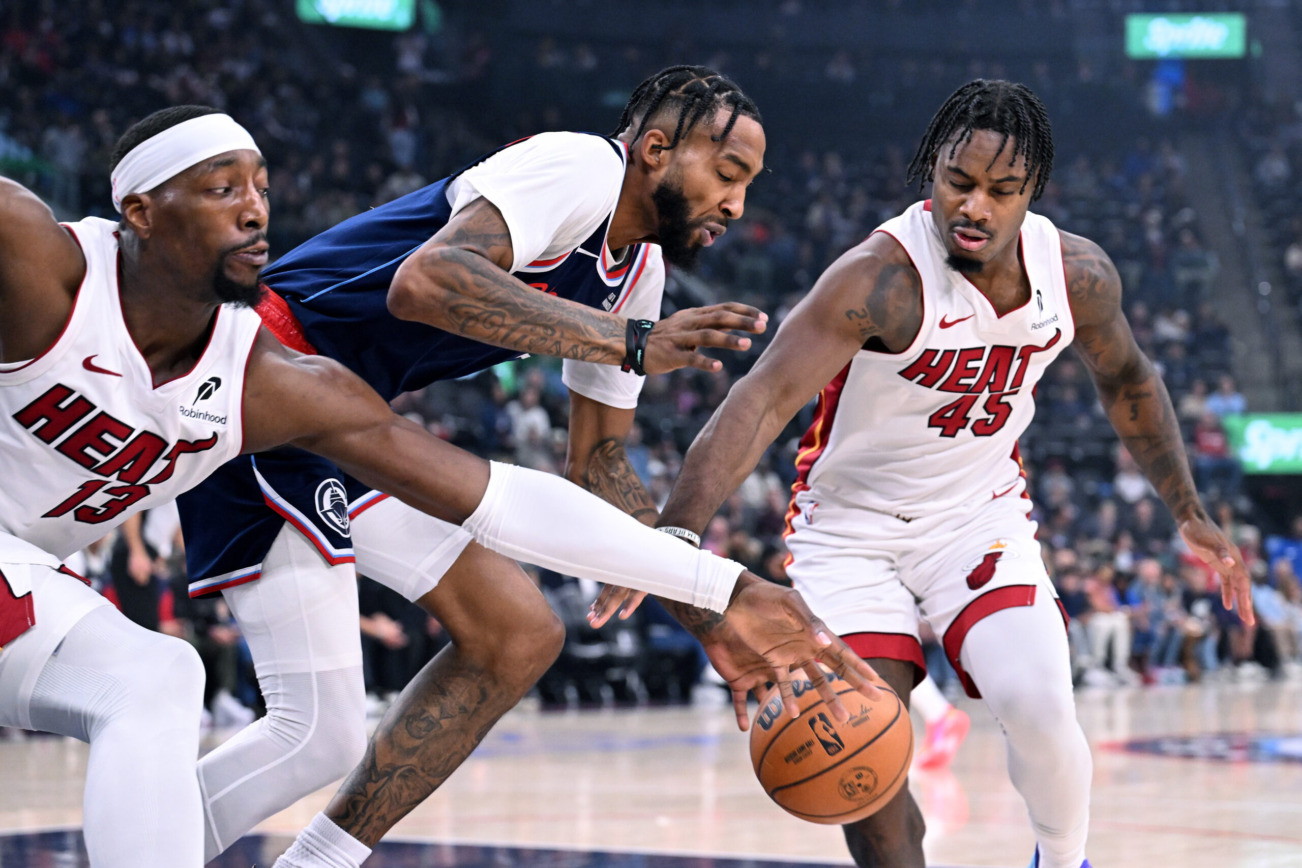 Miami Heat forward Bam Adebayo (13) and teammate Davion Mitchell...