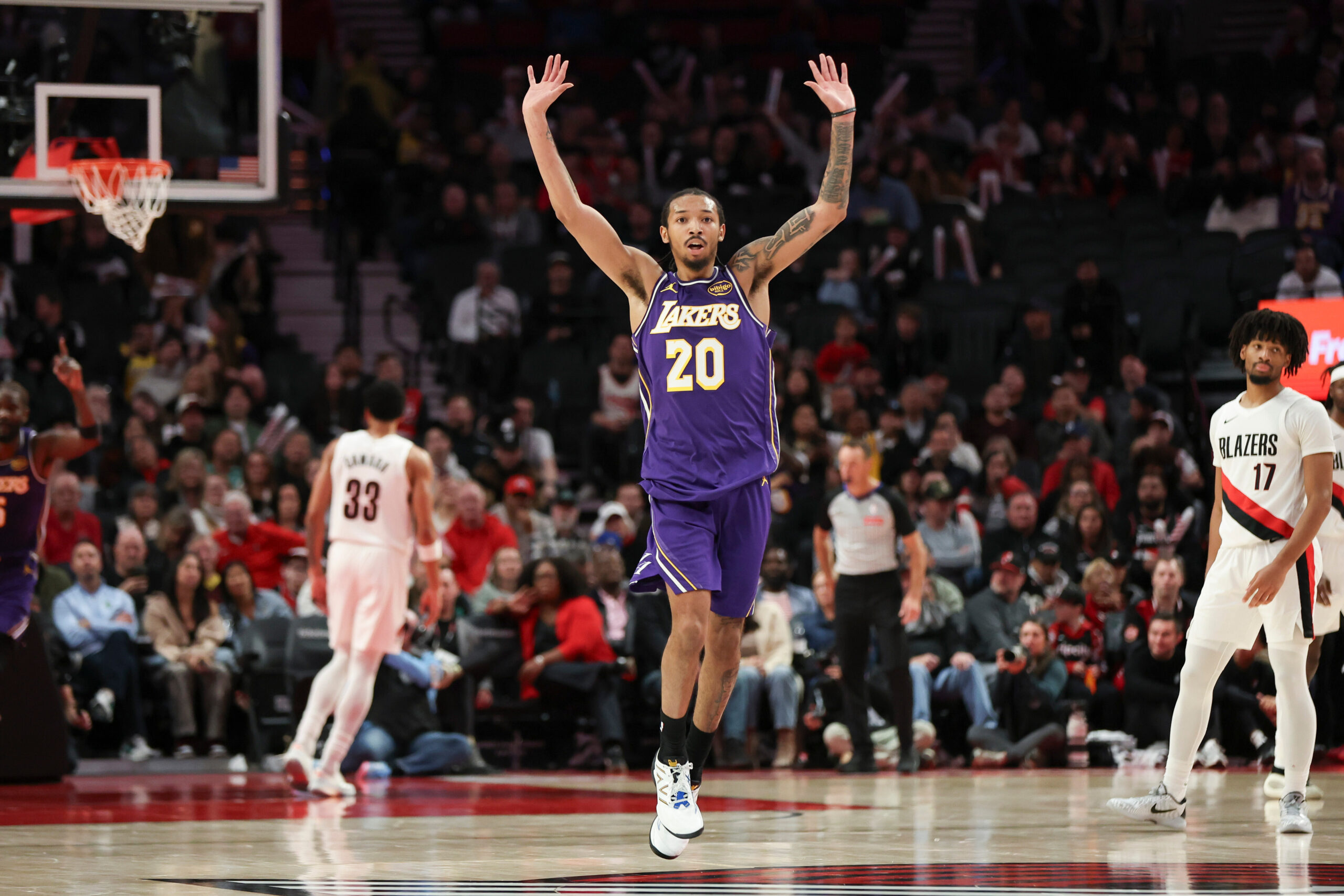 Lakers guard Nick Smith Jr. (20) reacts after a basket...