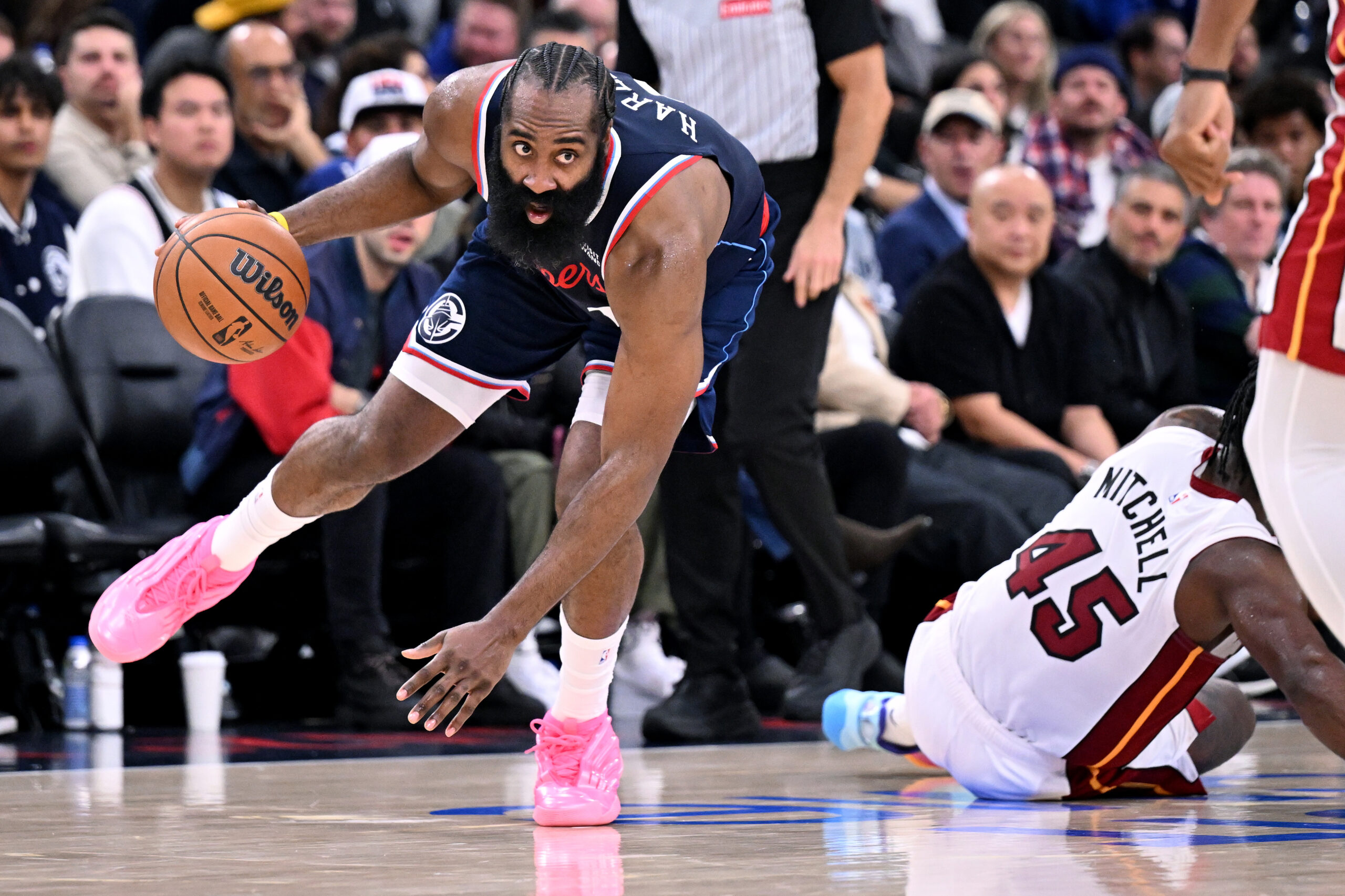 Clippers guard James Harden dribbles past Miami Heat guard Davion...