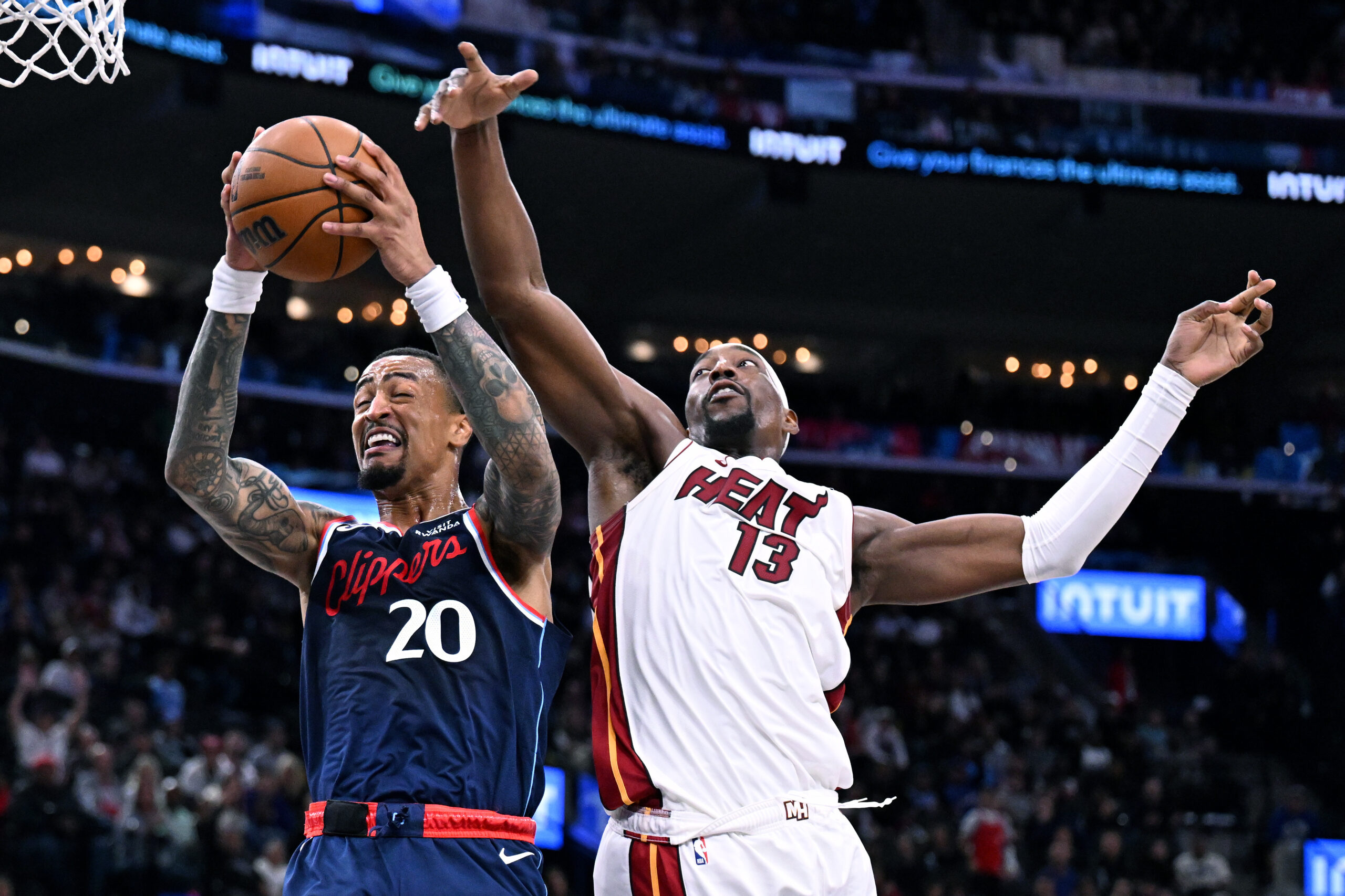 Clippers forward John Collins (20) drives past Miami Heat forward...