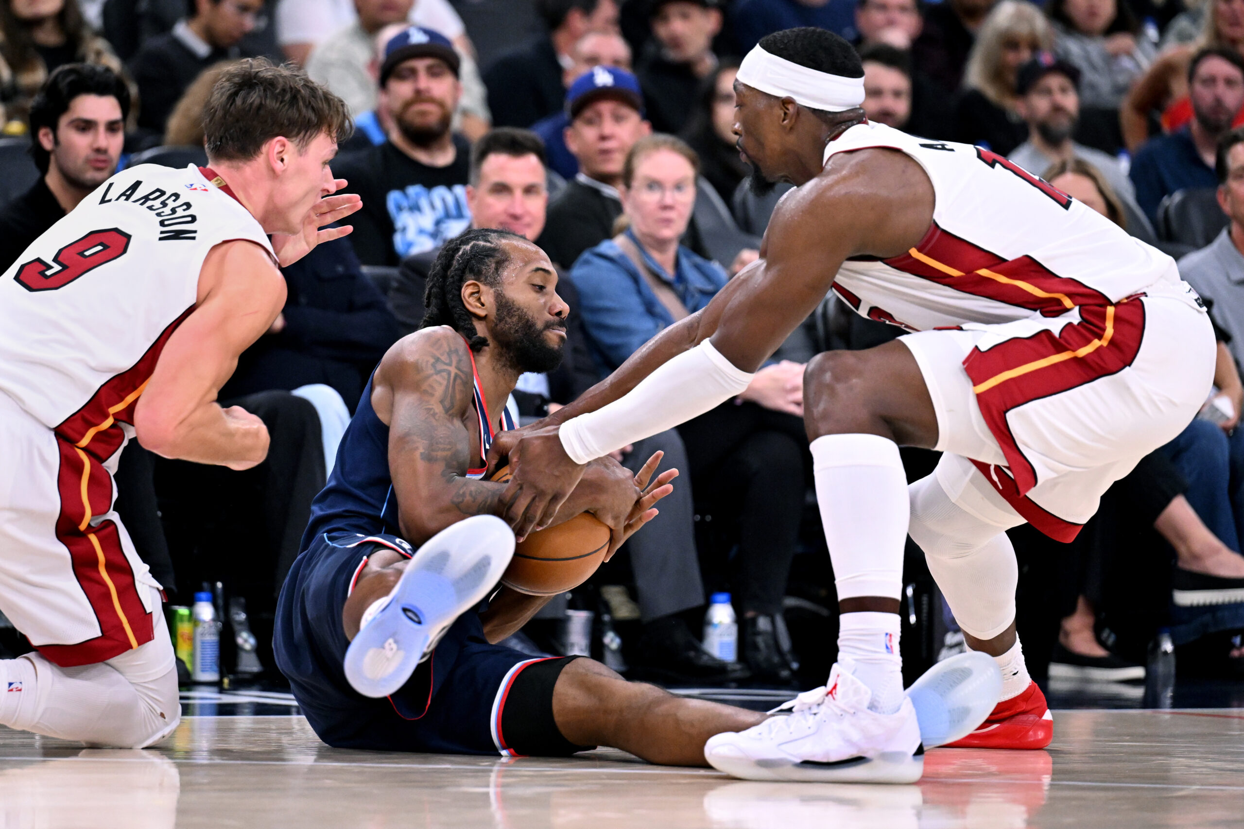 Clippers forward Kawhi Leonard is forced into a jump ball...