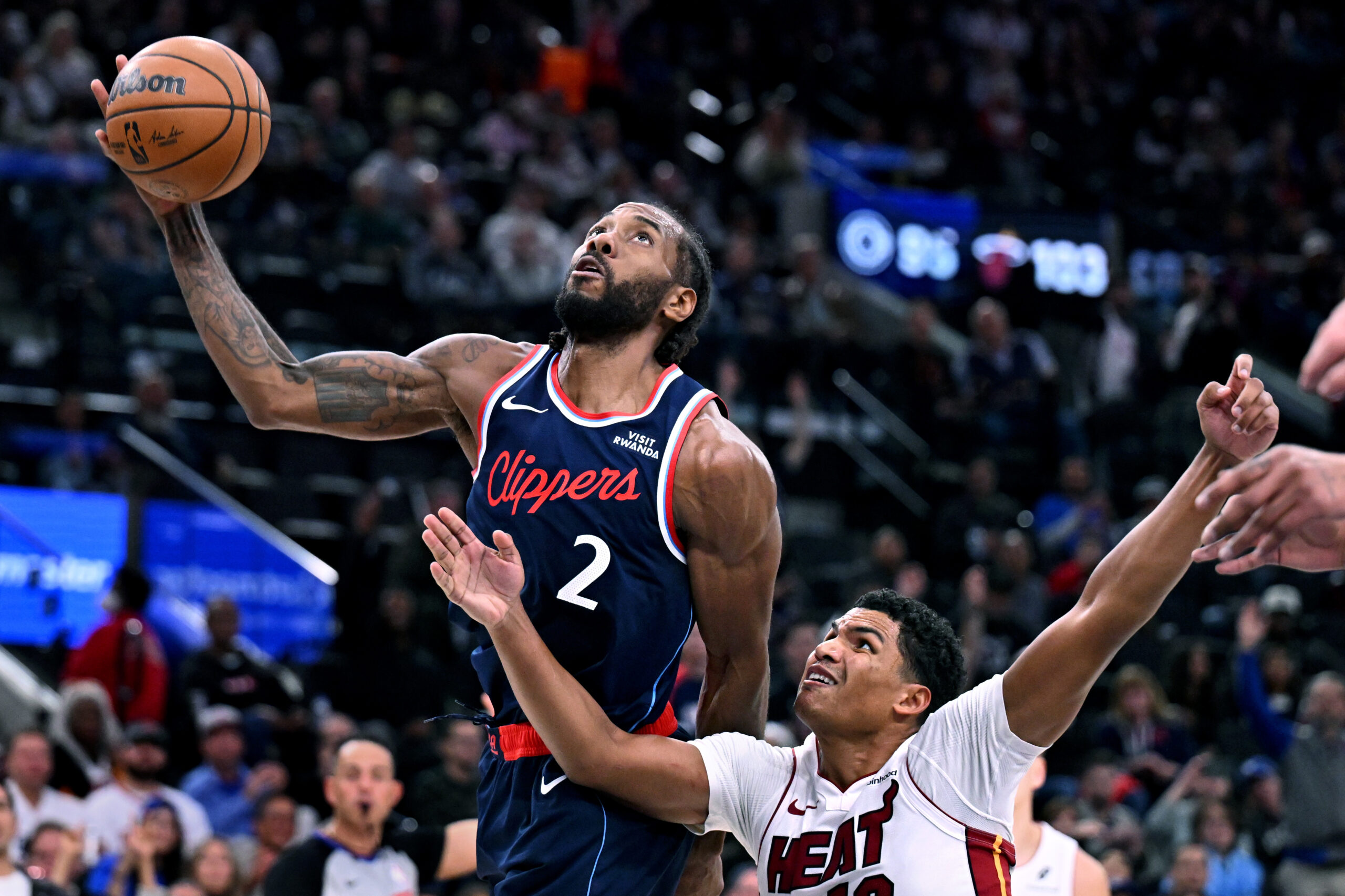 Clippers forward Kawhi Leonard grabs a rebound from Miami Heat...