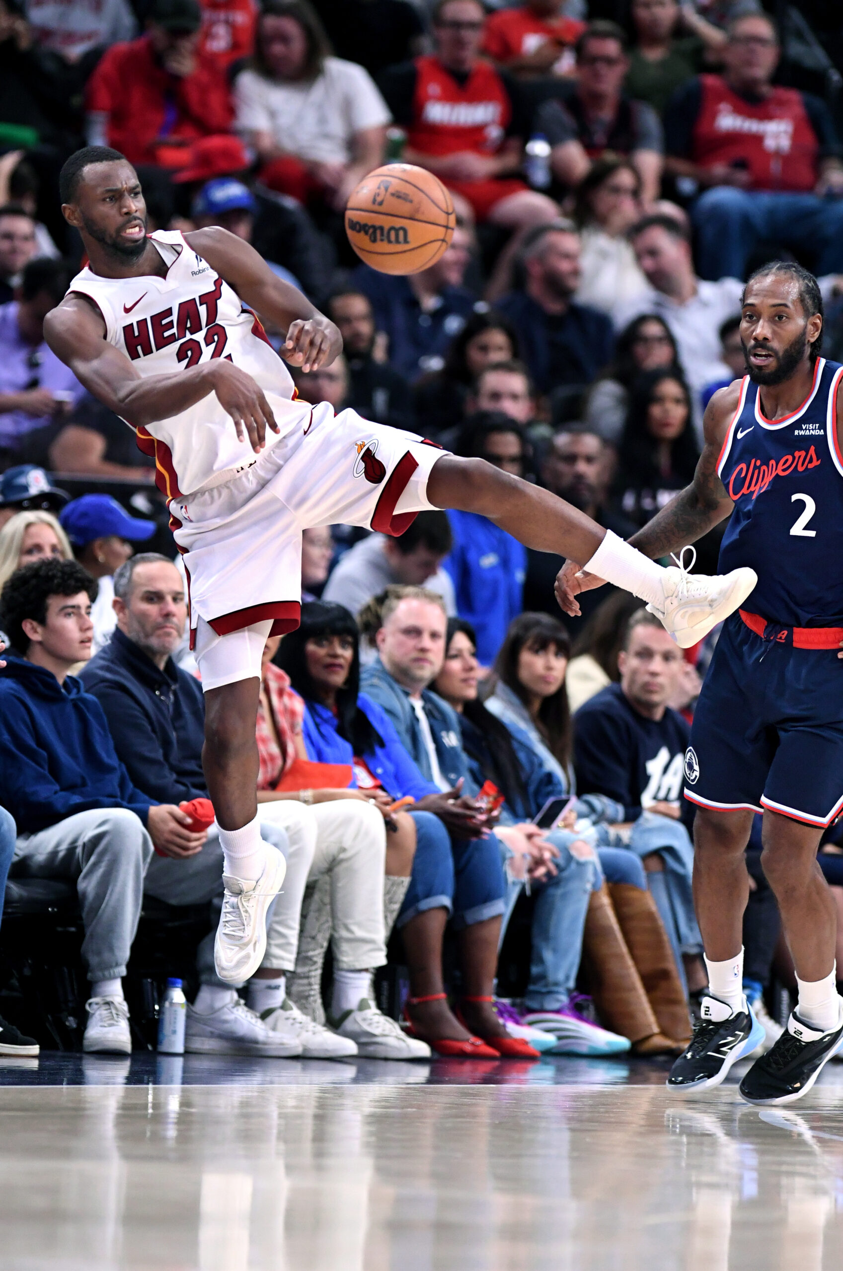 Miami Heat forward Andrew Wiggins (22) saves the ball from...
