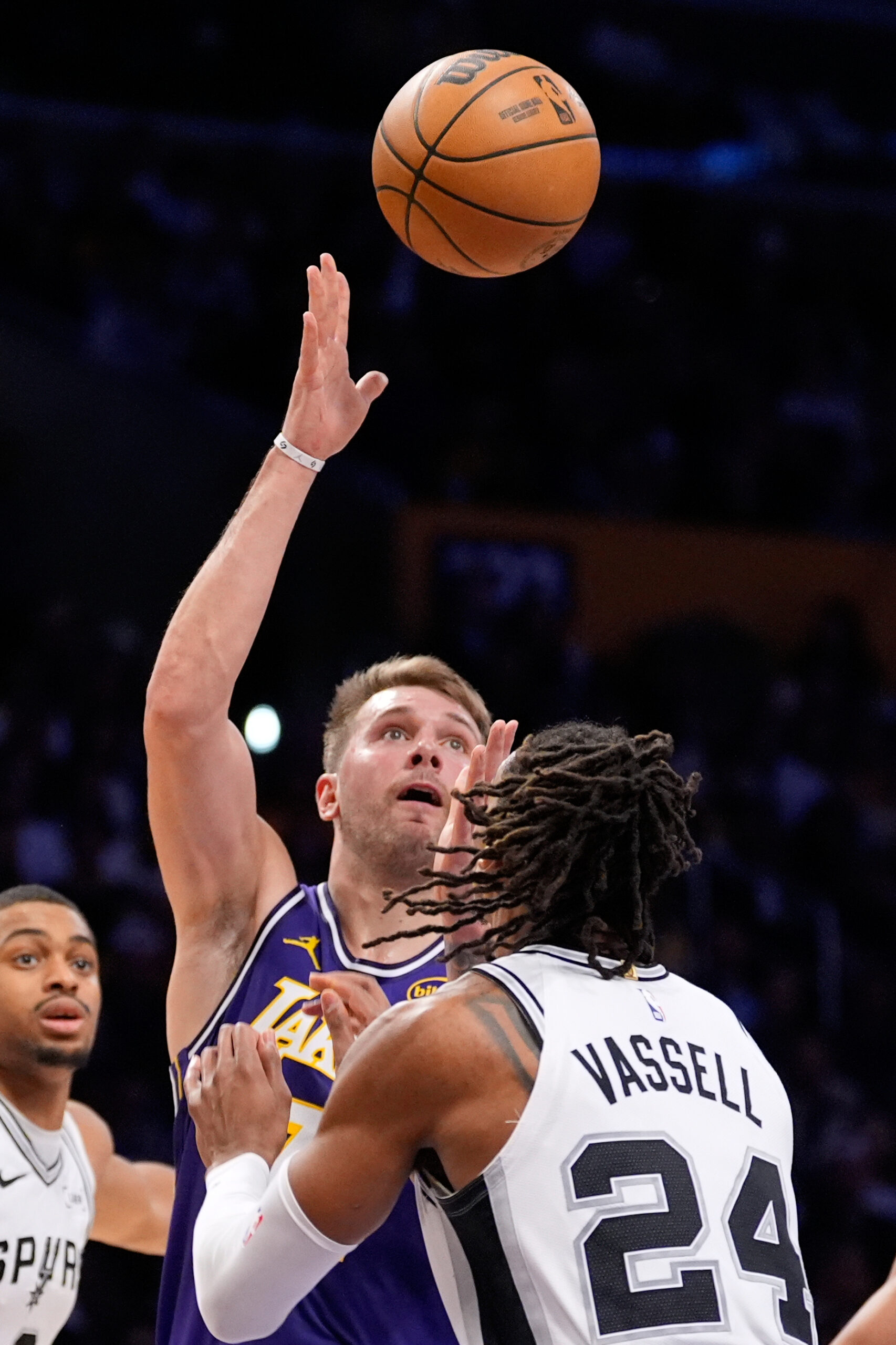 Lakers star Luka Doncic, center, shoots as San Antonio Spurs...