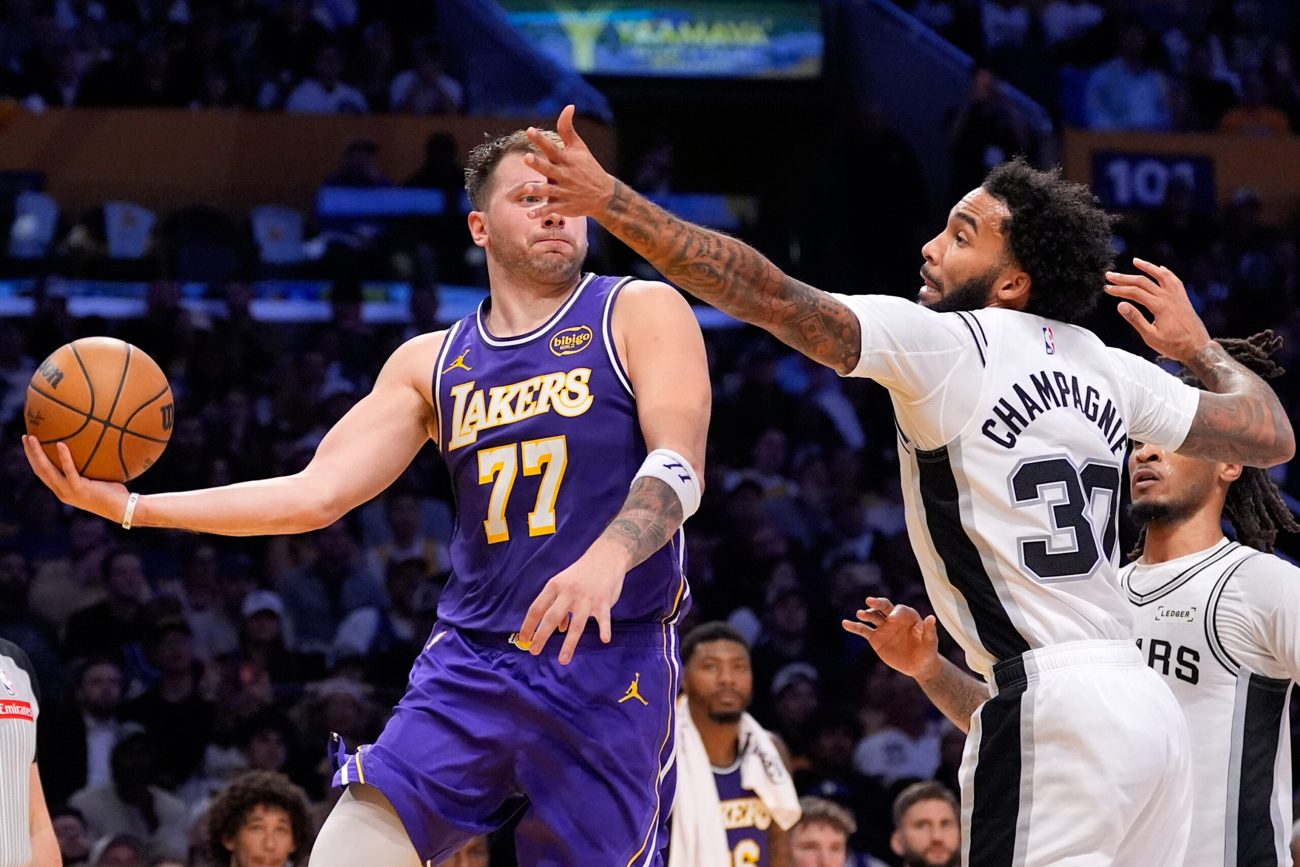 Lakers star Luka Doncic looks to pass the ball as...