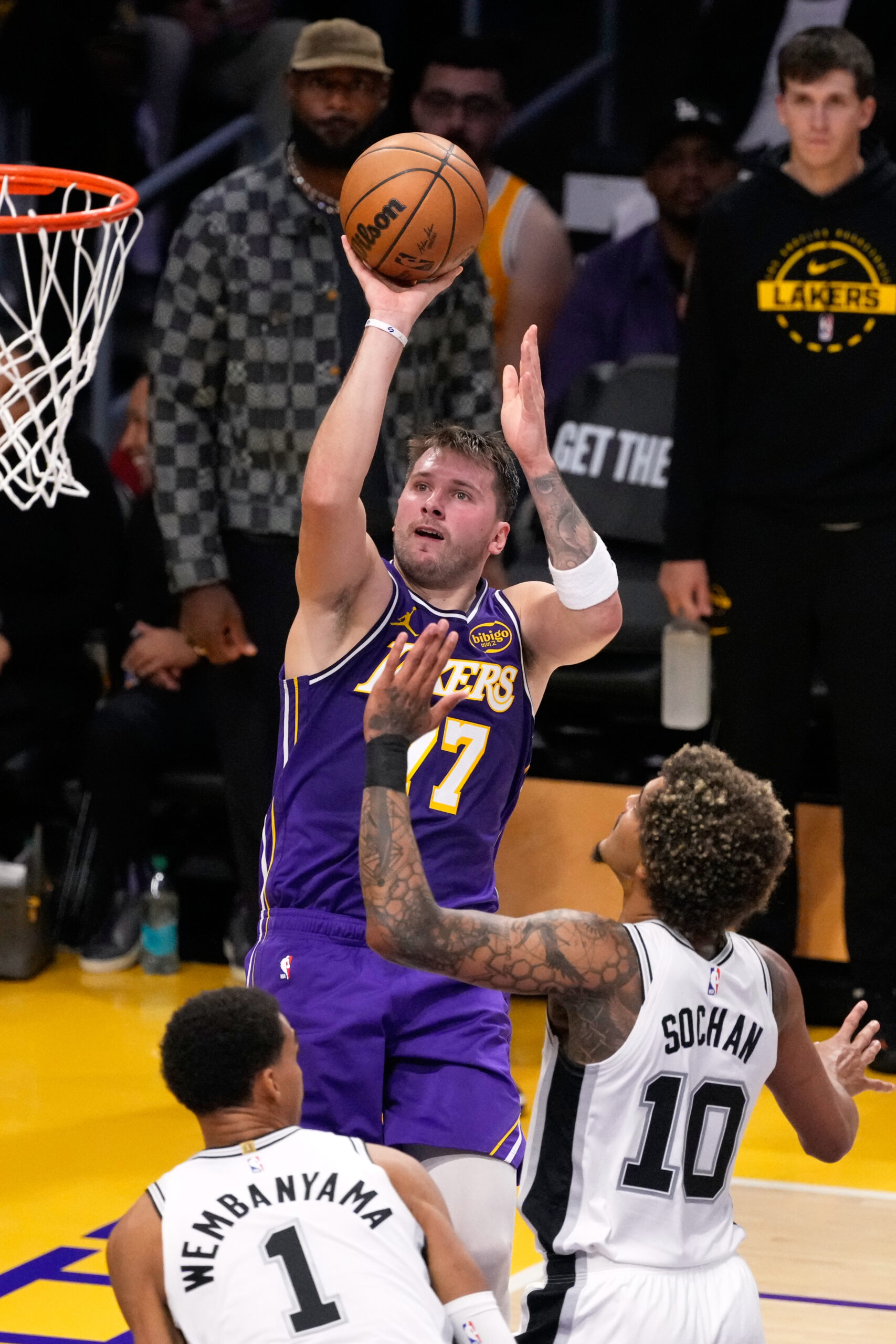 Lakers star Luka Doncic, left, shoots as San Antonio Spurs...