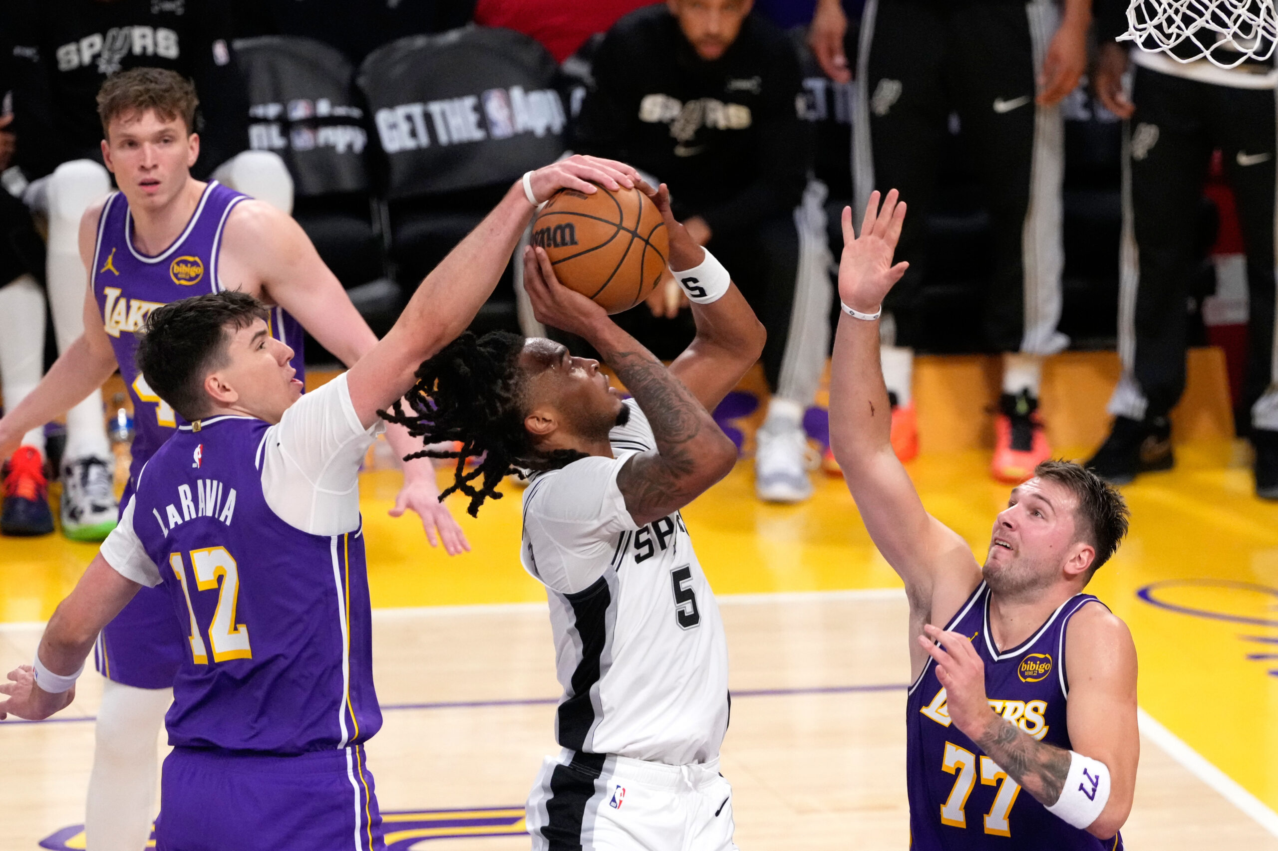 Lakers forward Jake LaRavia, left, blocks the shot of San...