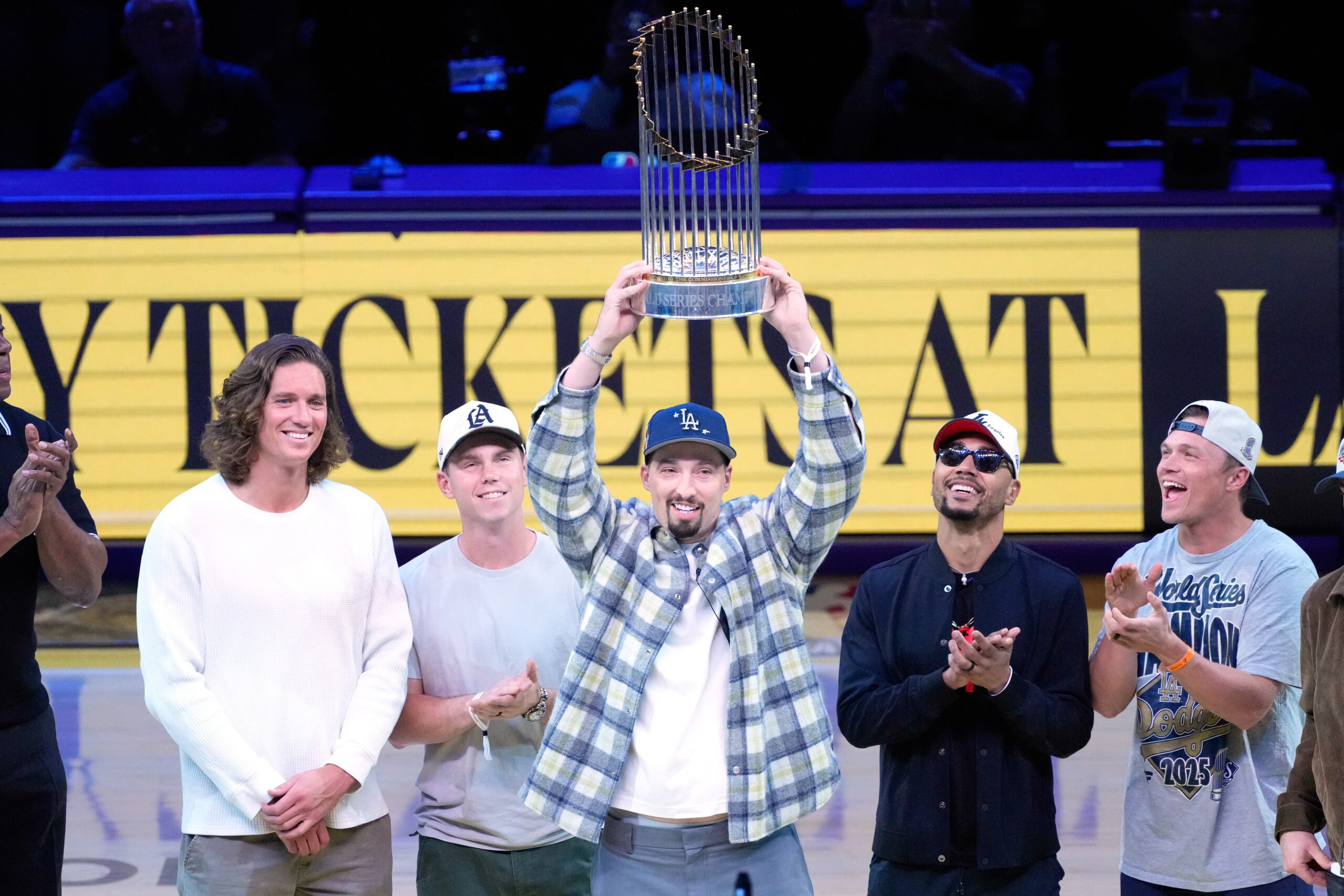 Members of the World Series champion Dodgers stand at center...