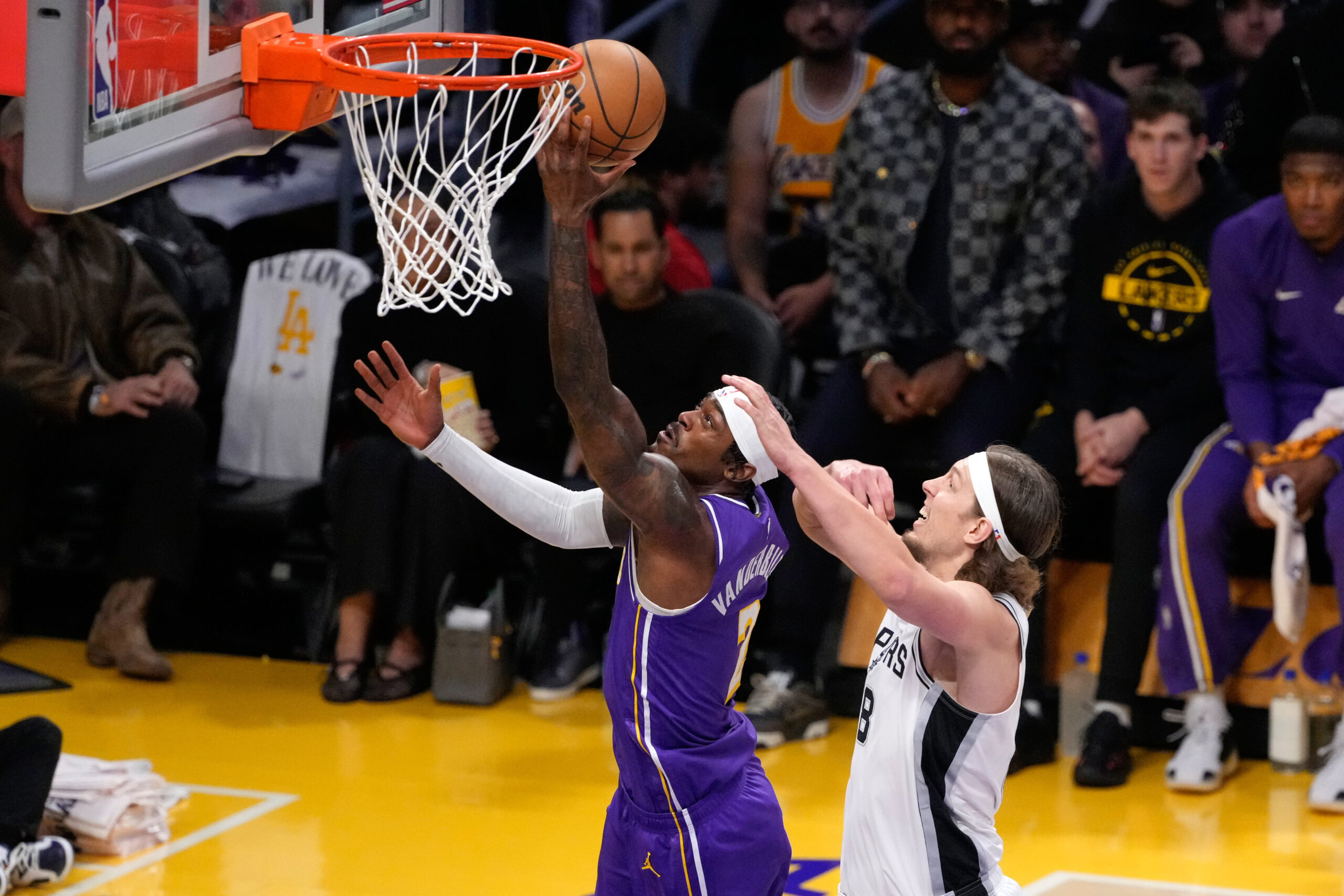Lakers guard Gabe Vincent, left, shoots as San Antonio Spurs...