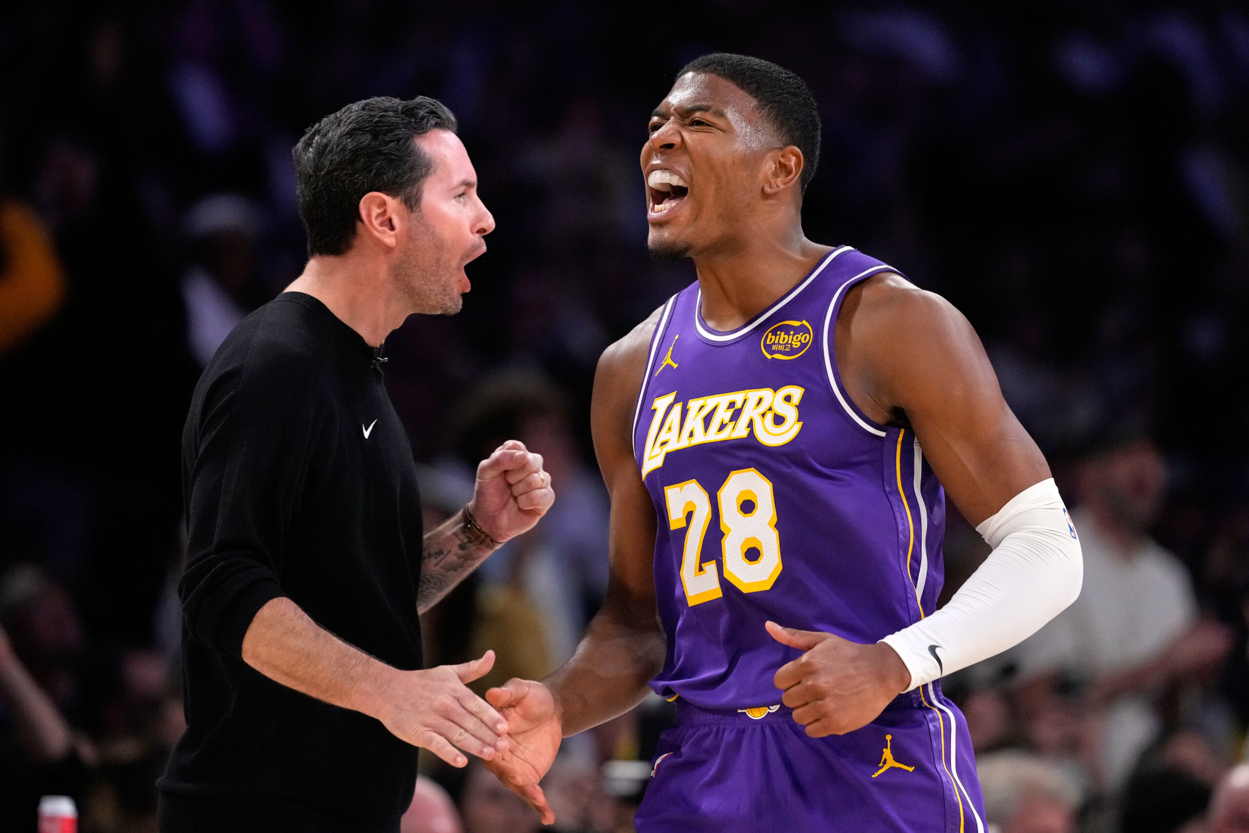 Lakers forward Rui Hachimura, right, celebrates with head coach JJ...