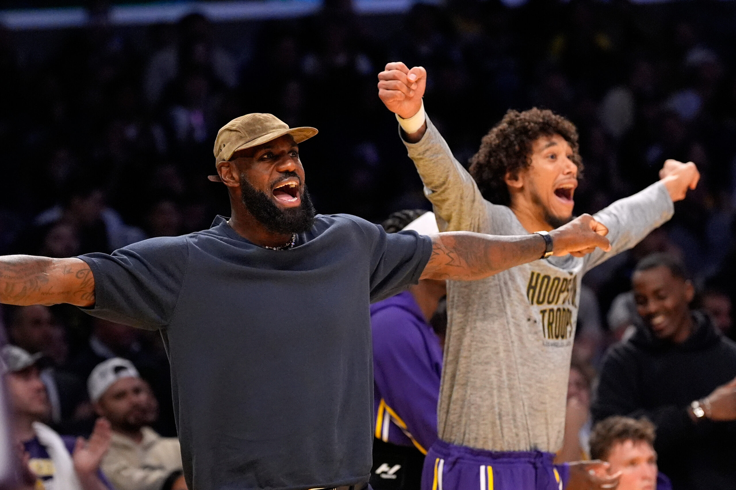 Injured Lakers star LeBron James, left, and center Jaxson Hayes...