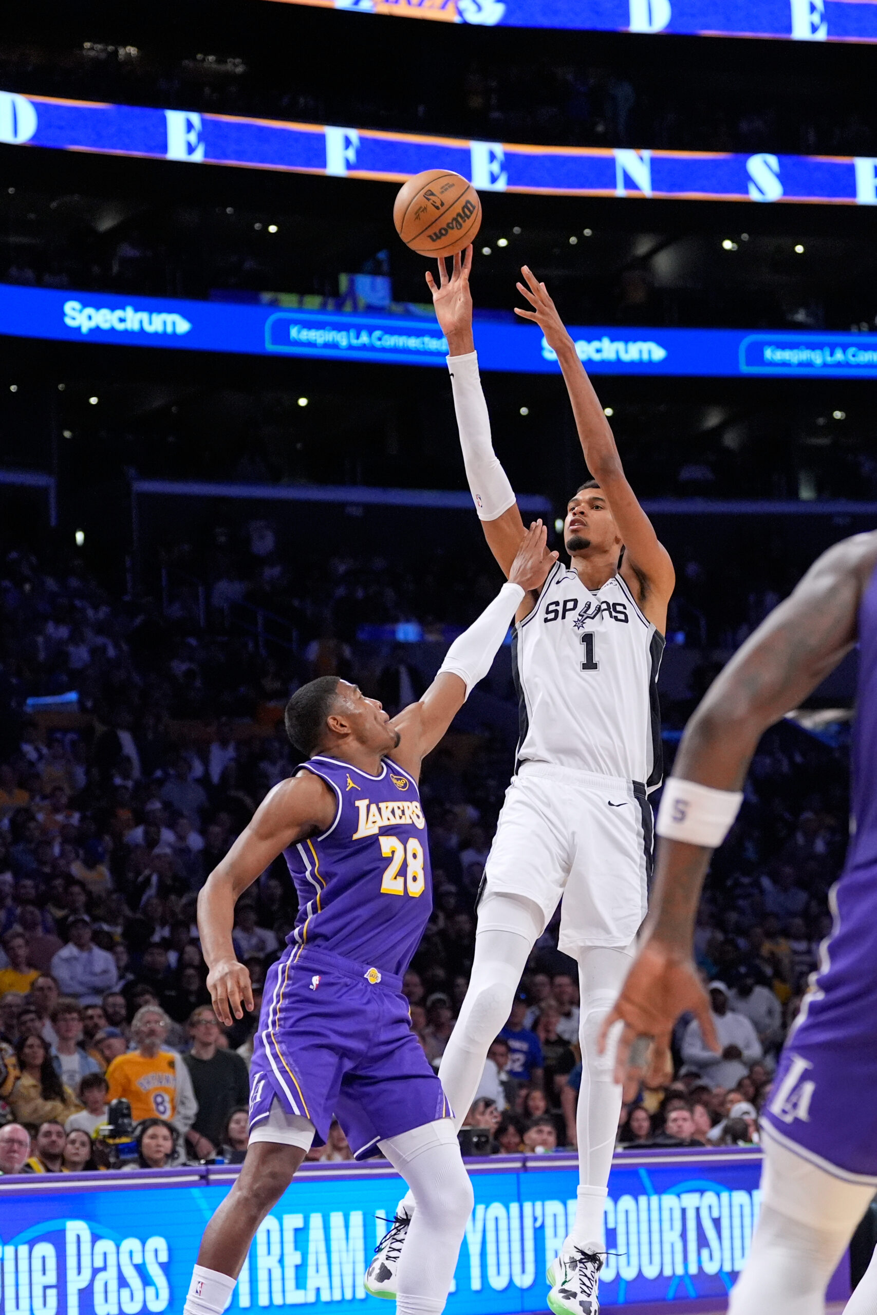San Antonio Spurs star Victor Wembanyama, right, shoots as Lakers...