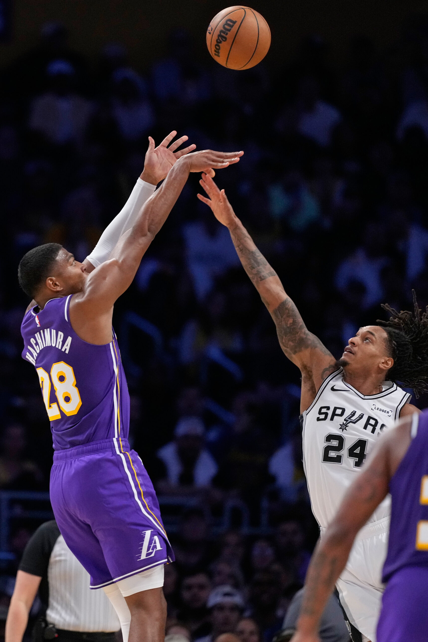 Lakers forward Rui Hachimura, left, shoots as San Antonio Spurs...