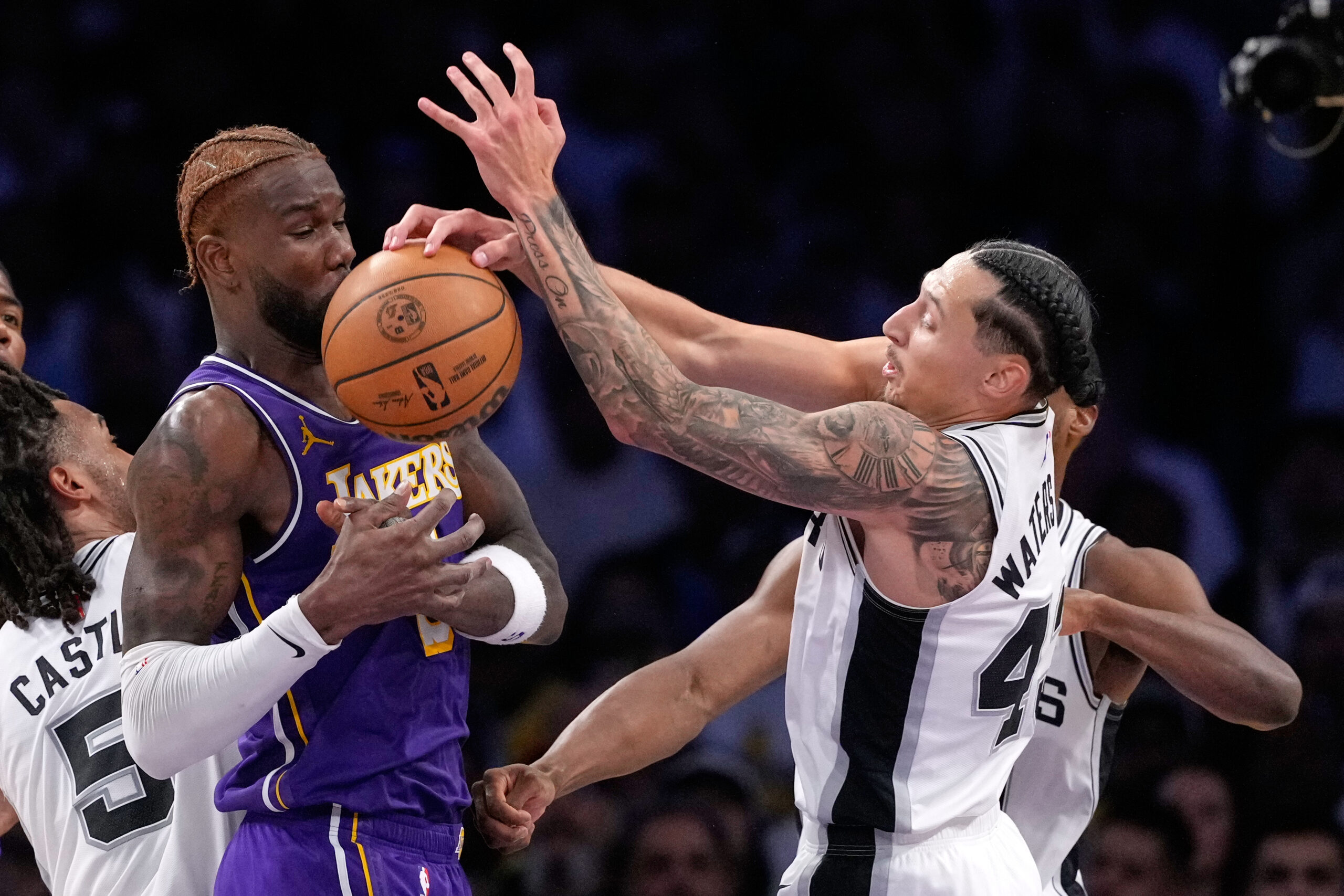 Lakers center Deandre Ayton, left, and San Antonio Spurs forward...