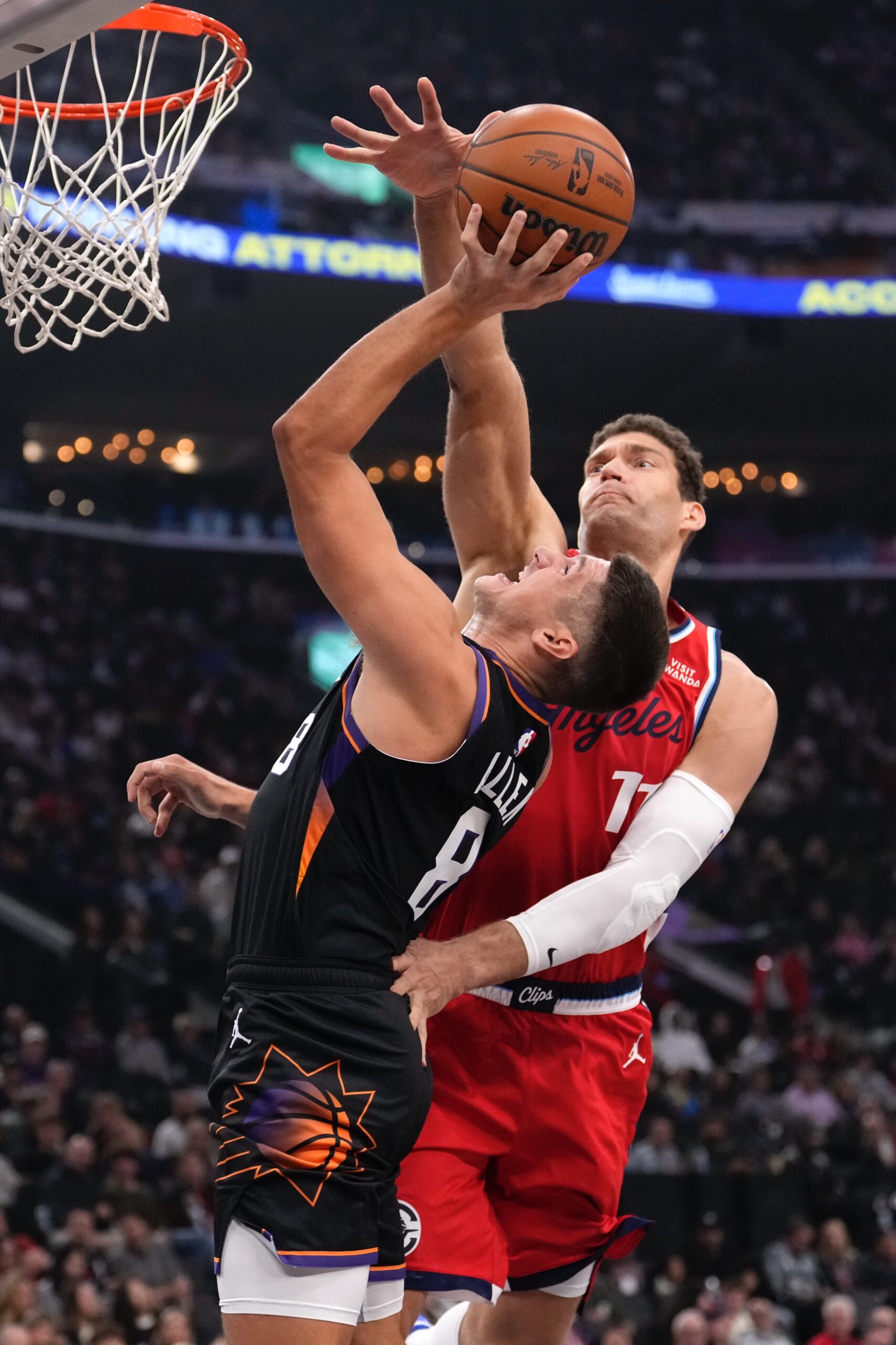 Phoenix Suns guard Grayson Allen, left, shoots as Clippers center...