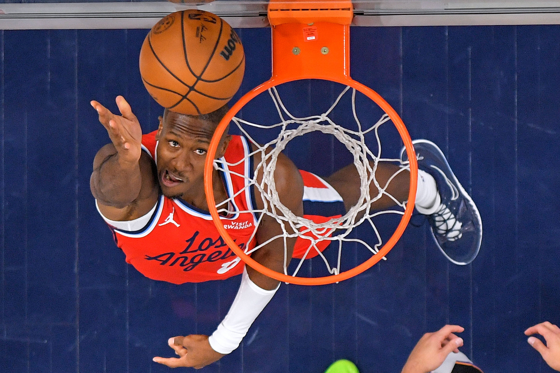 Clippers guard Kris Dunn, left, shoots during the first half...