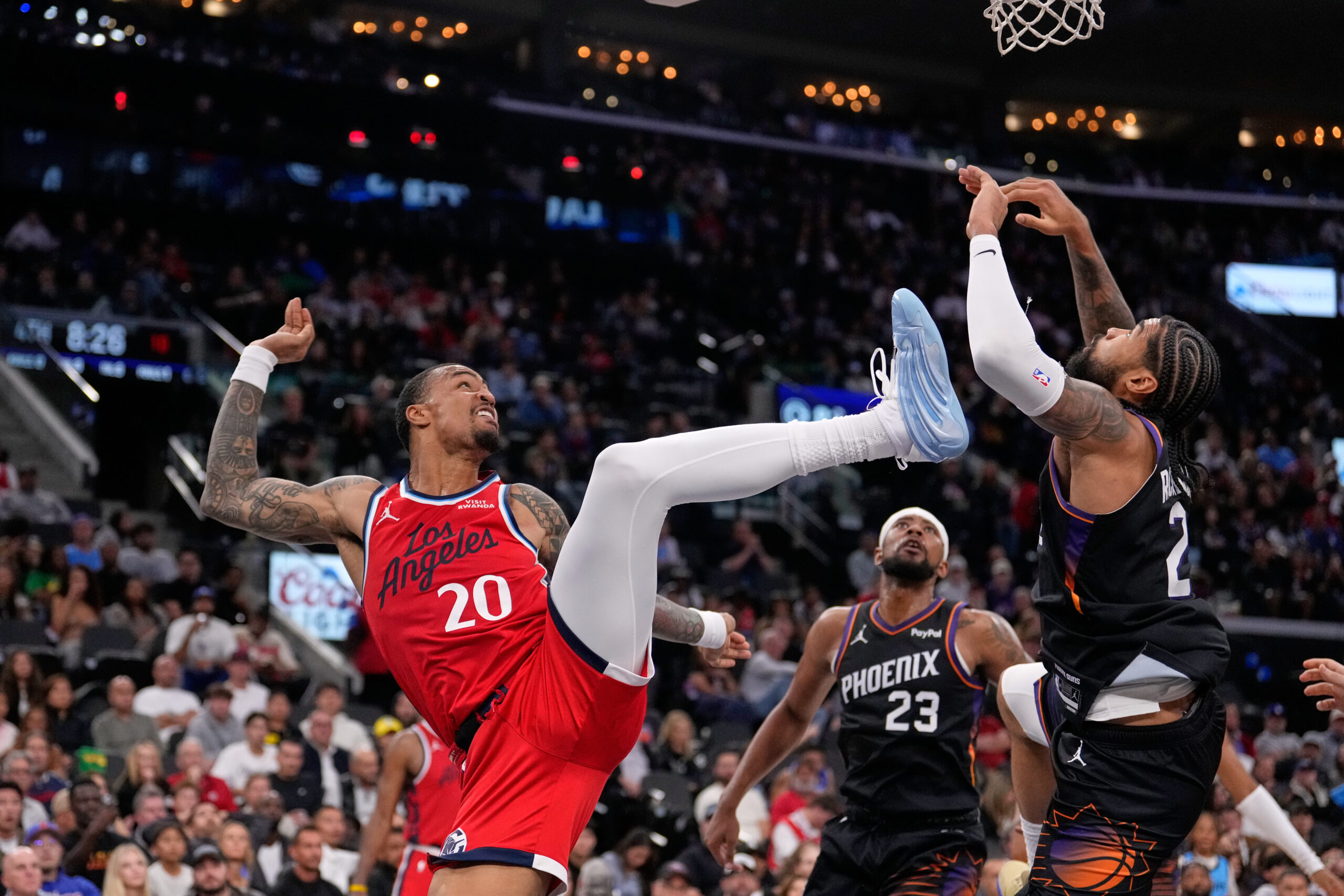 Clippers forward John Collins, left, Phoenix Suns guard Jordan Goodwin,...