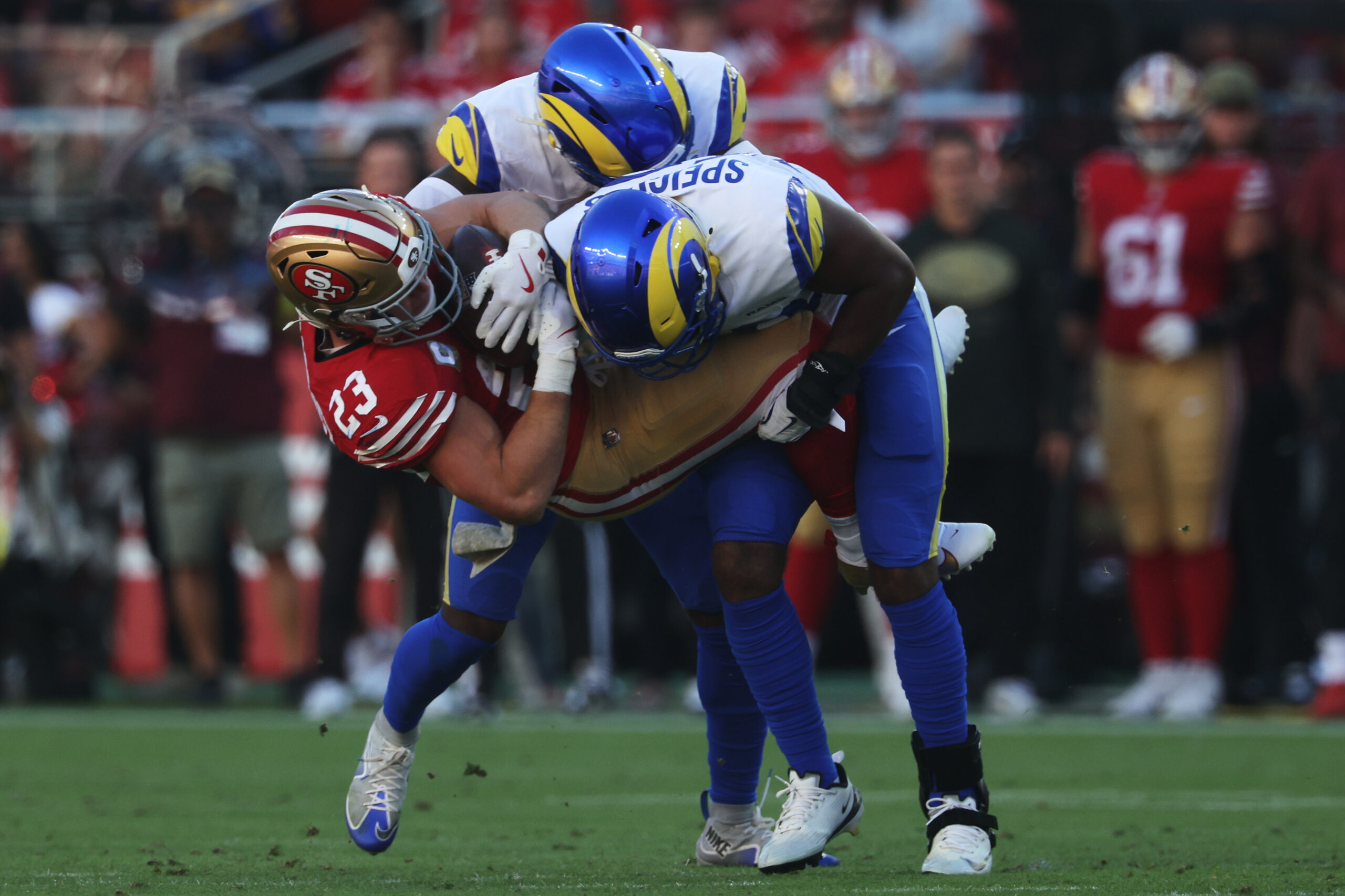 San Francisco 49ers running back Christian McCaffrey (23) is tackled...