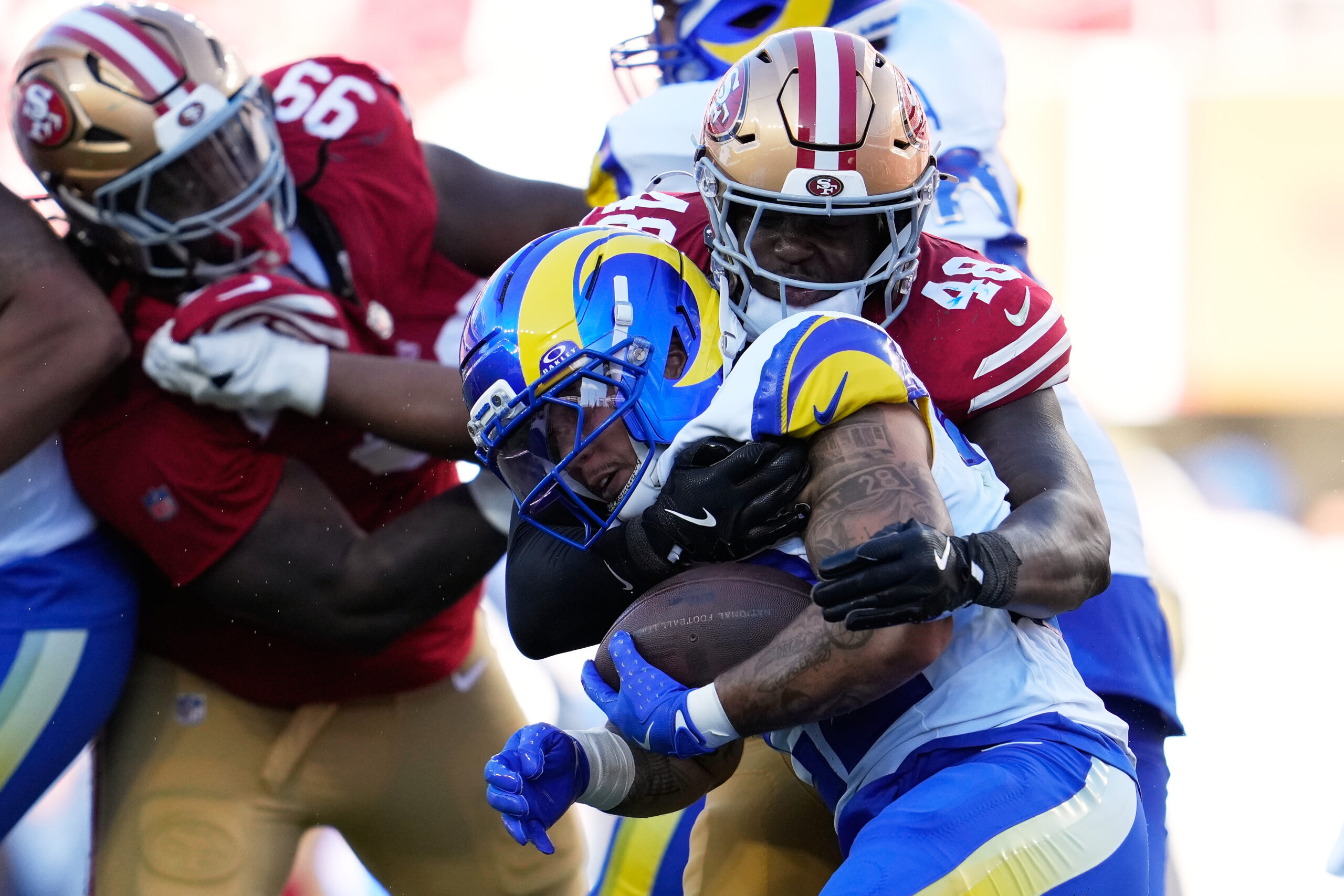 Rams running back Blake Corum, foreground, is tackled by San...