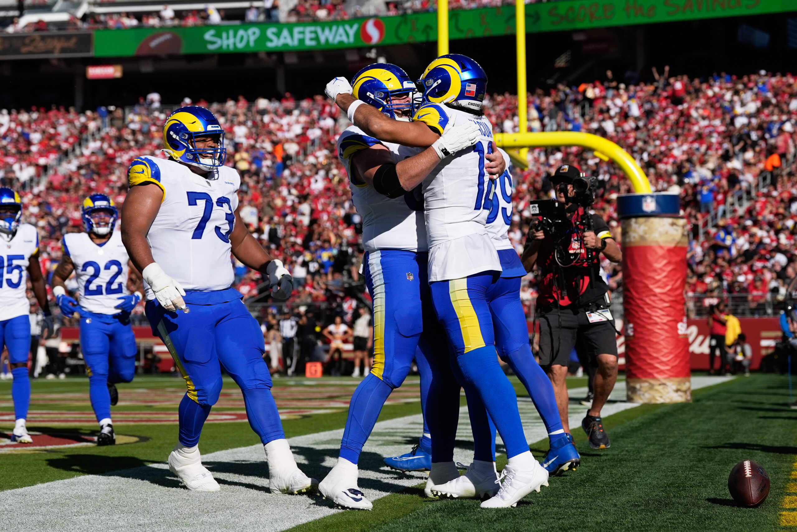 Rams wide receiver Puka Nacua, right, is congratulated by teammates...