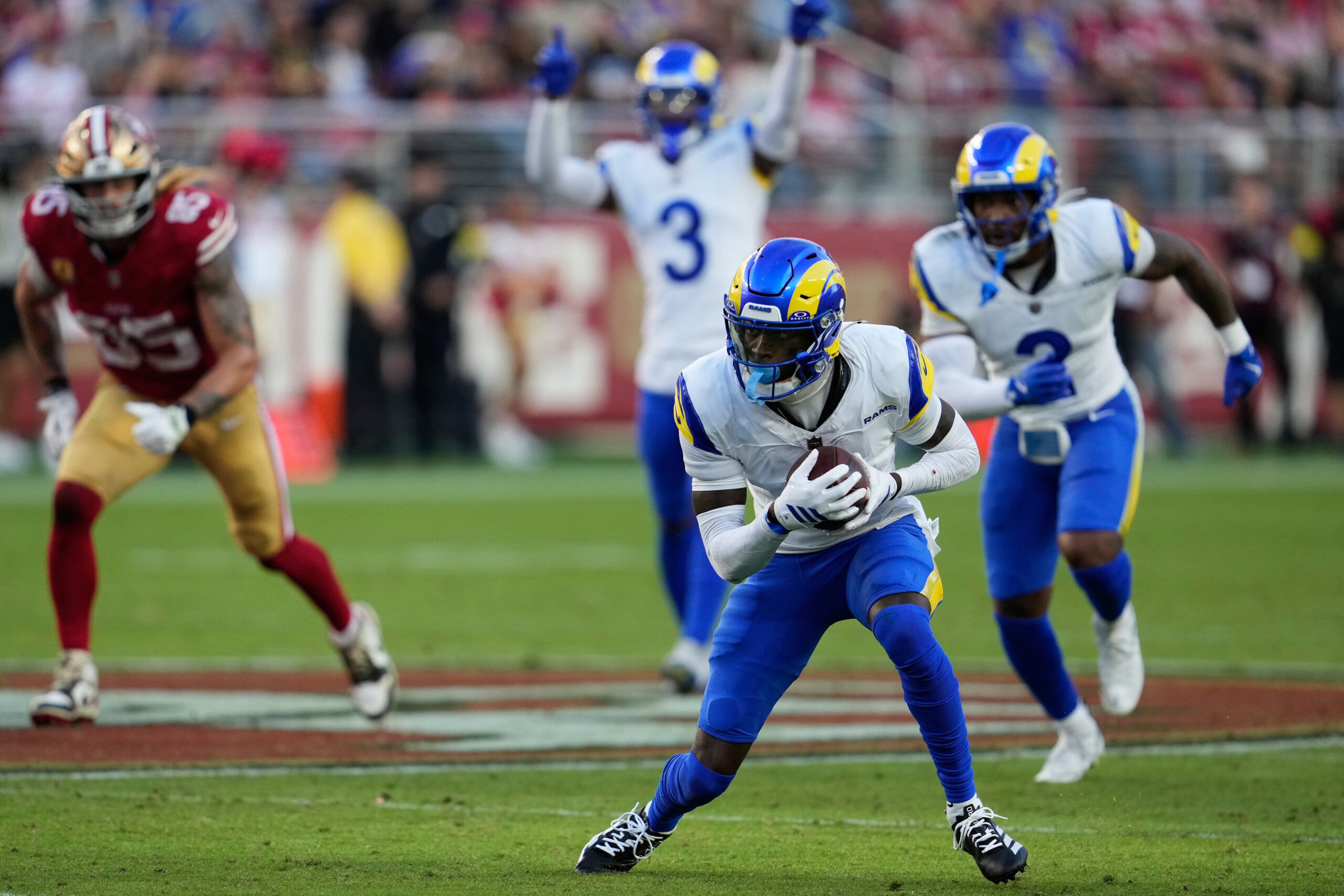 Rams cornerback Emmanuel Forbes Jr., bottom, returns an interception against...